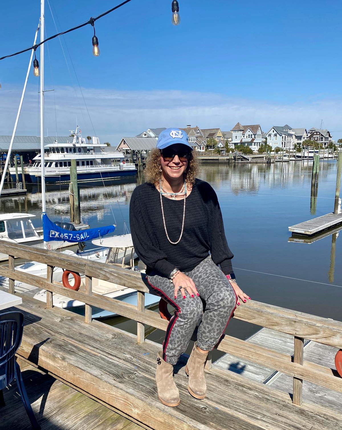 a person sitting on a dock next to a body of water