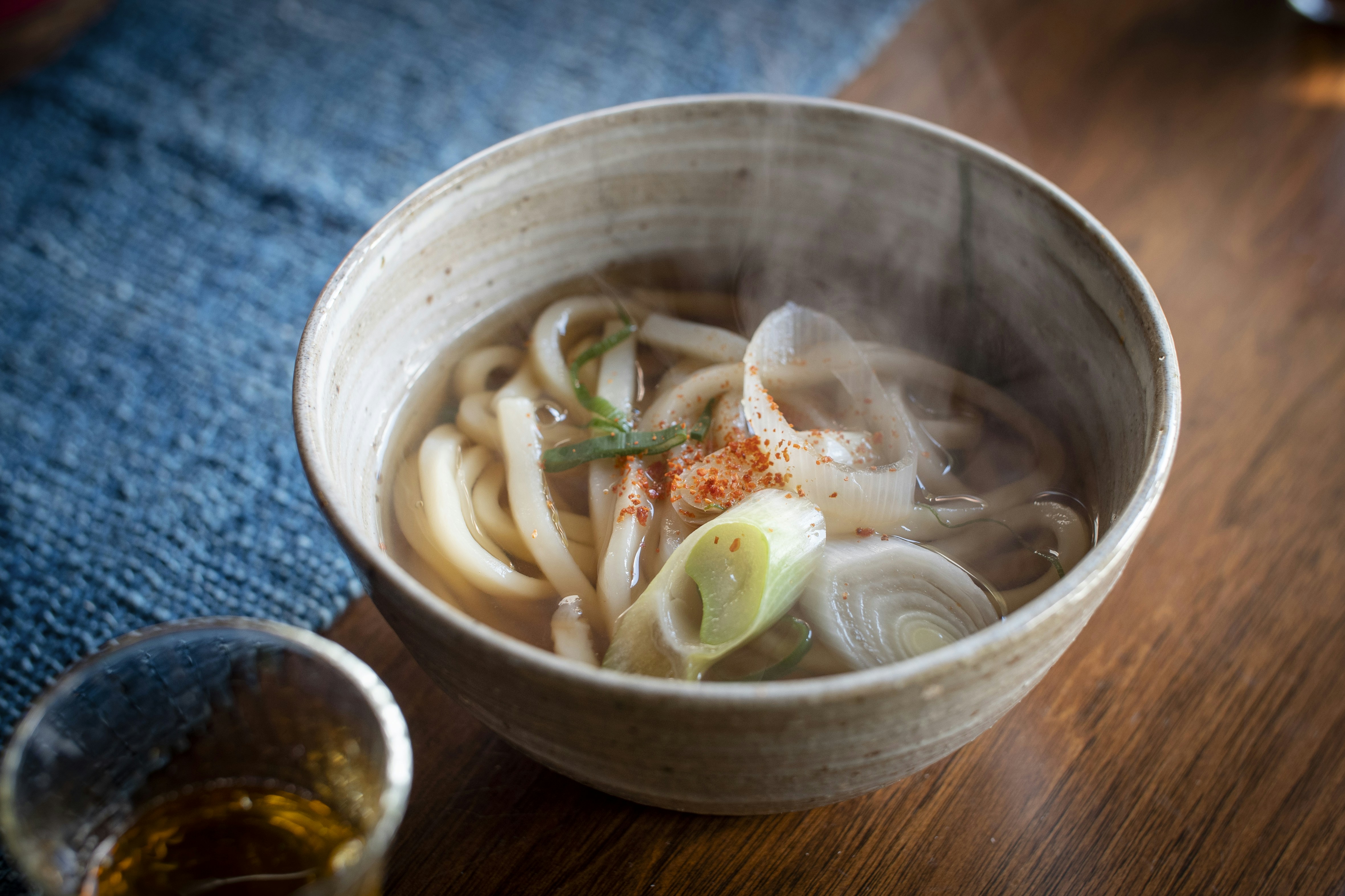 a bowl of soup and a spoon on a table