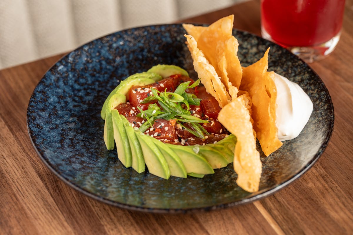 a plate of food sitting on top of a wooden table