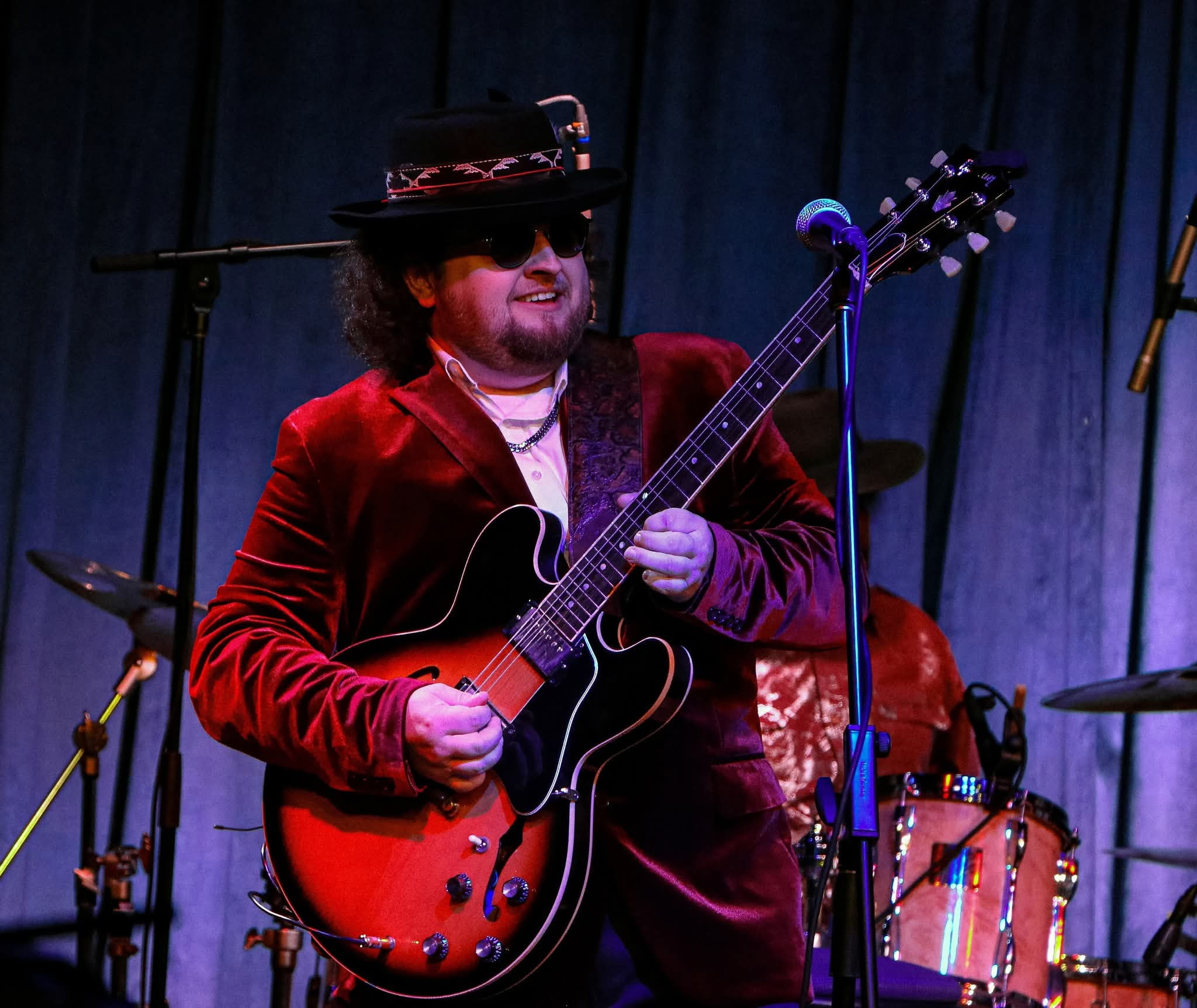 Colt Ford on a stage holding a guitar