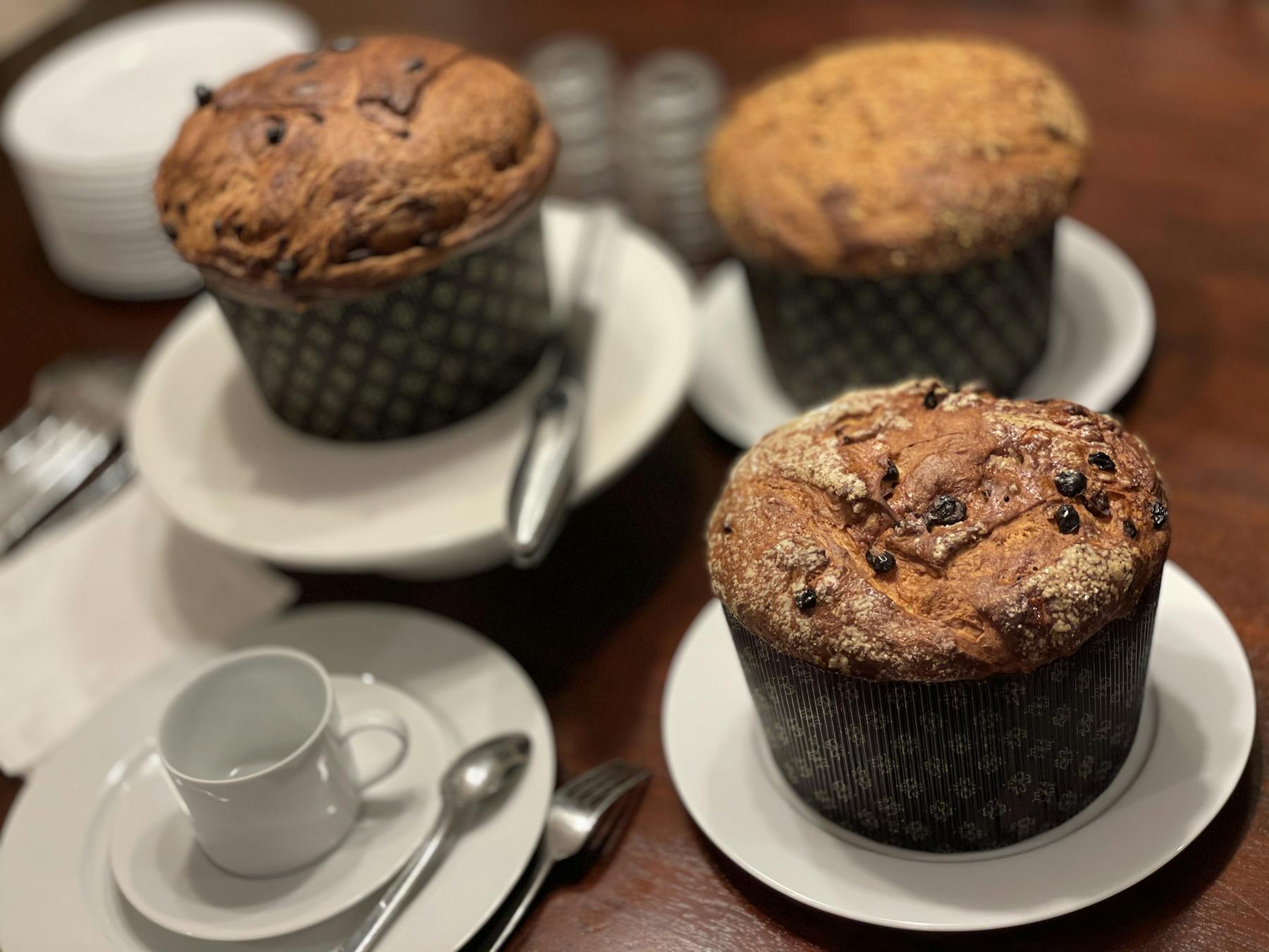 a piece of cake on a plate next to a cup of coffee