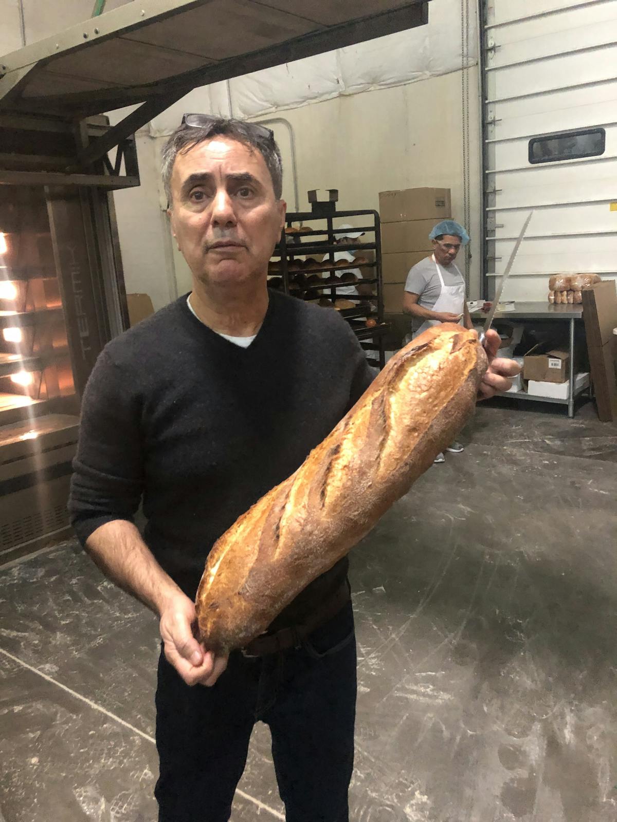 a man holding a baguette