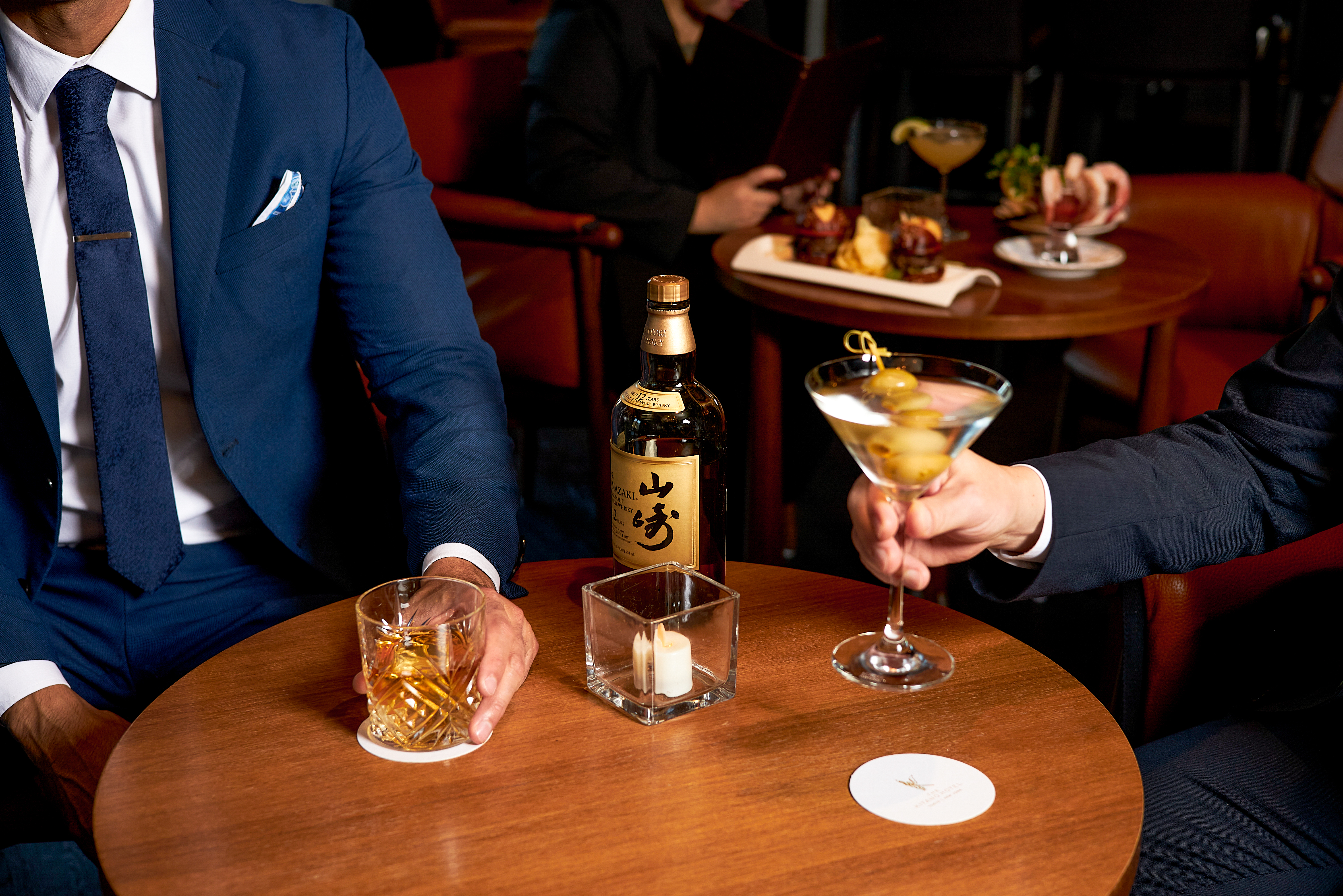a person sitting at a table with wine glasses