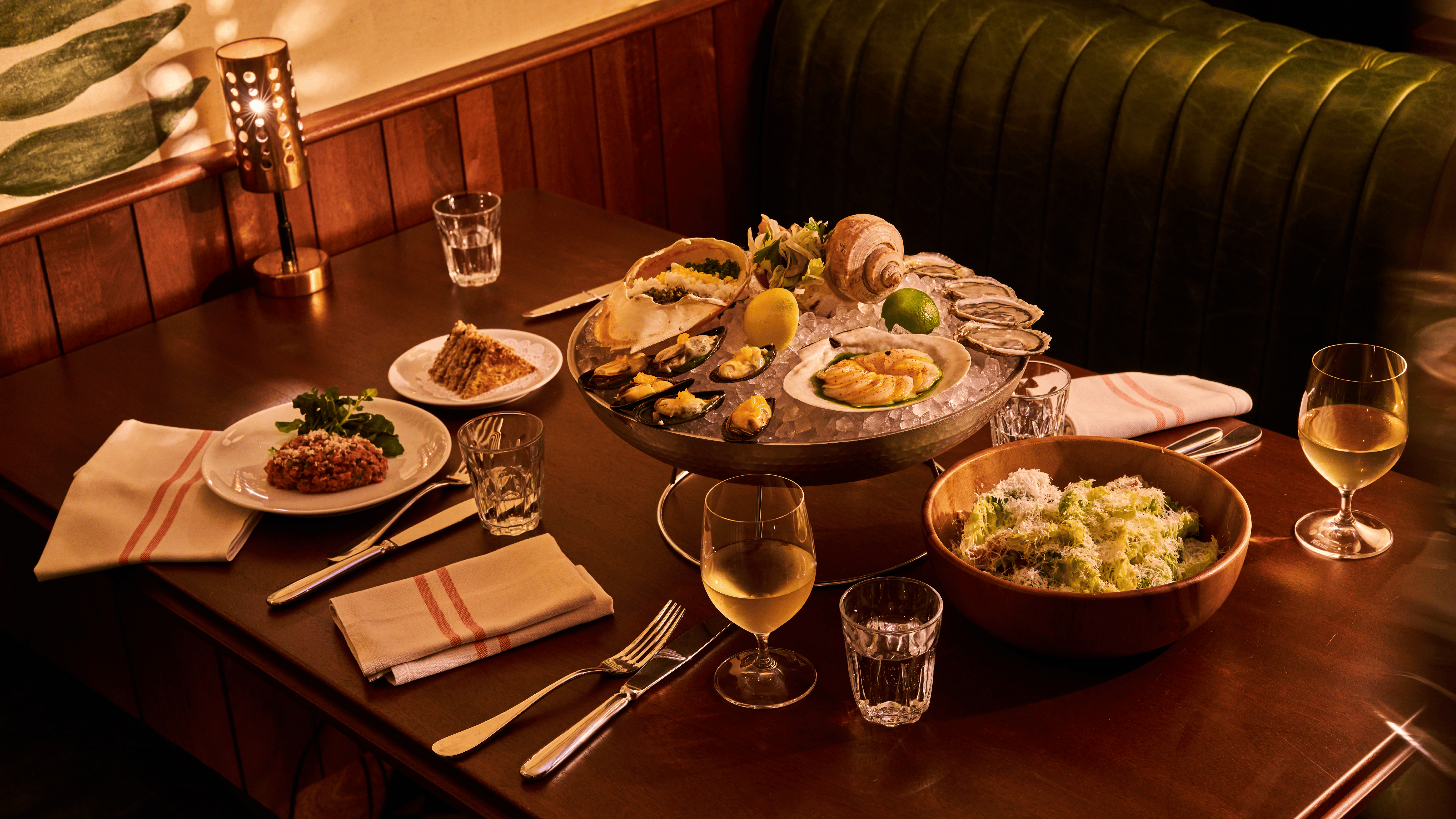 a plate of food and glasses of wine on a table