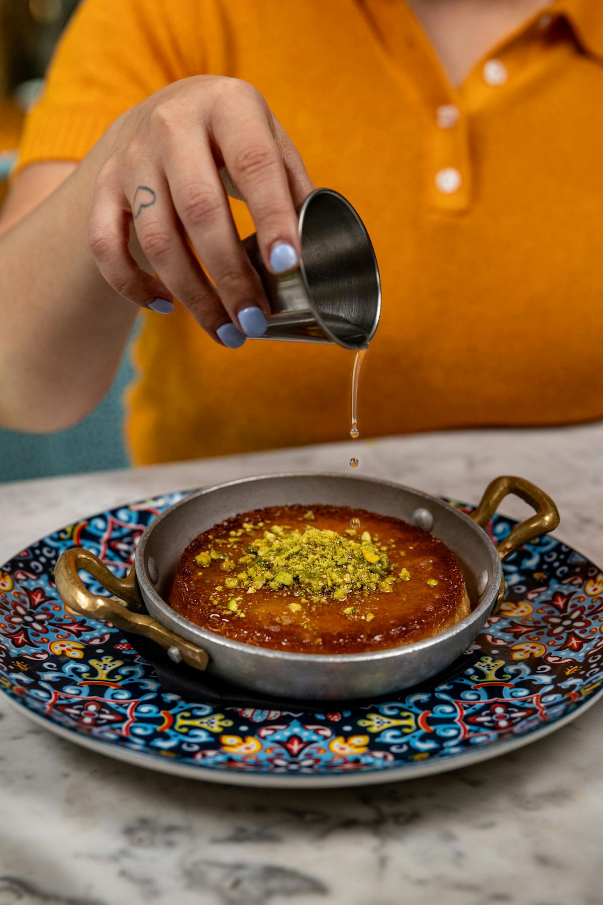 a plate of food with a knife on a cutting board with a cake