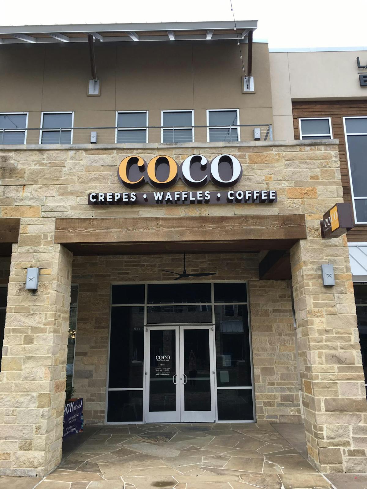 a sign in front of a brick building