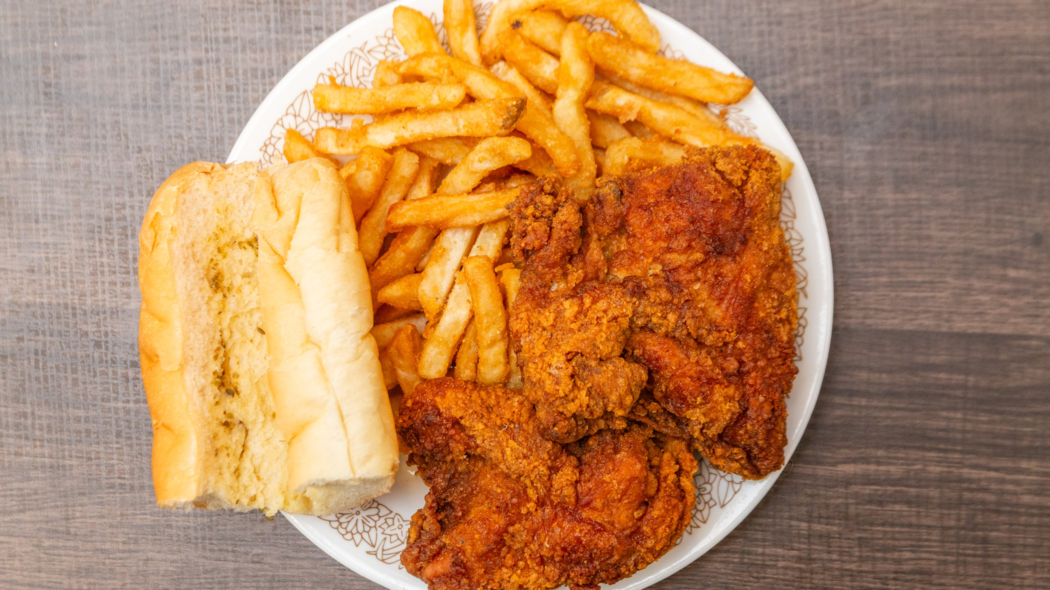 a plate of fried chicken and french fries