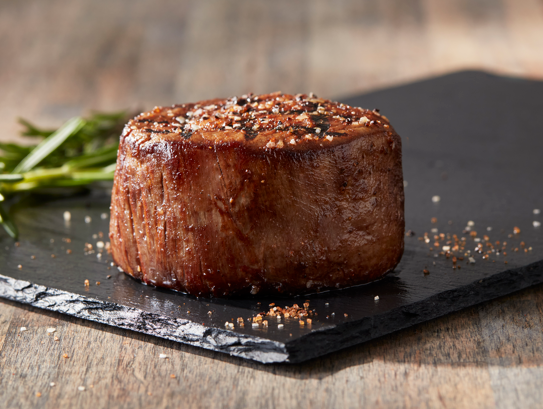 a piece of cake sitting on top of a wooden cutting board
