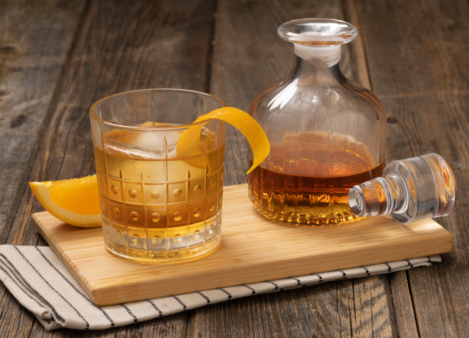 a cup of coffee sitting on top of a wooden cutting board