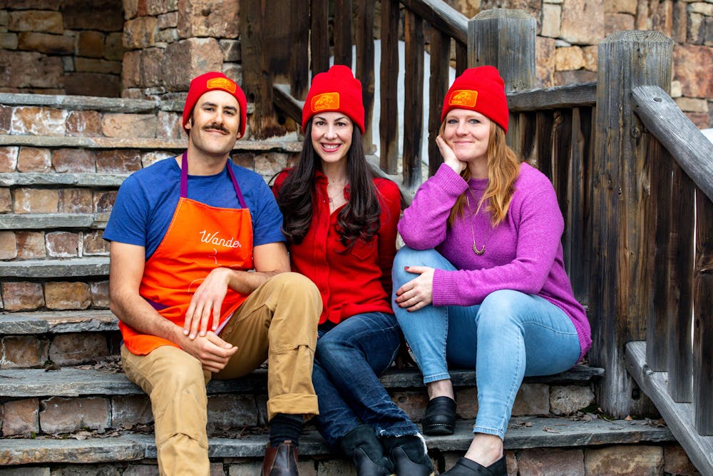 a couple of people that are sitting on a bench posing for the camera