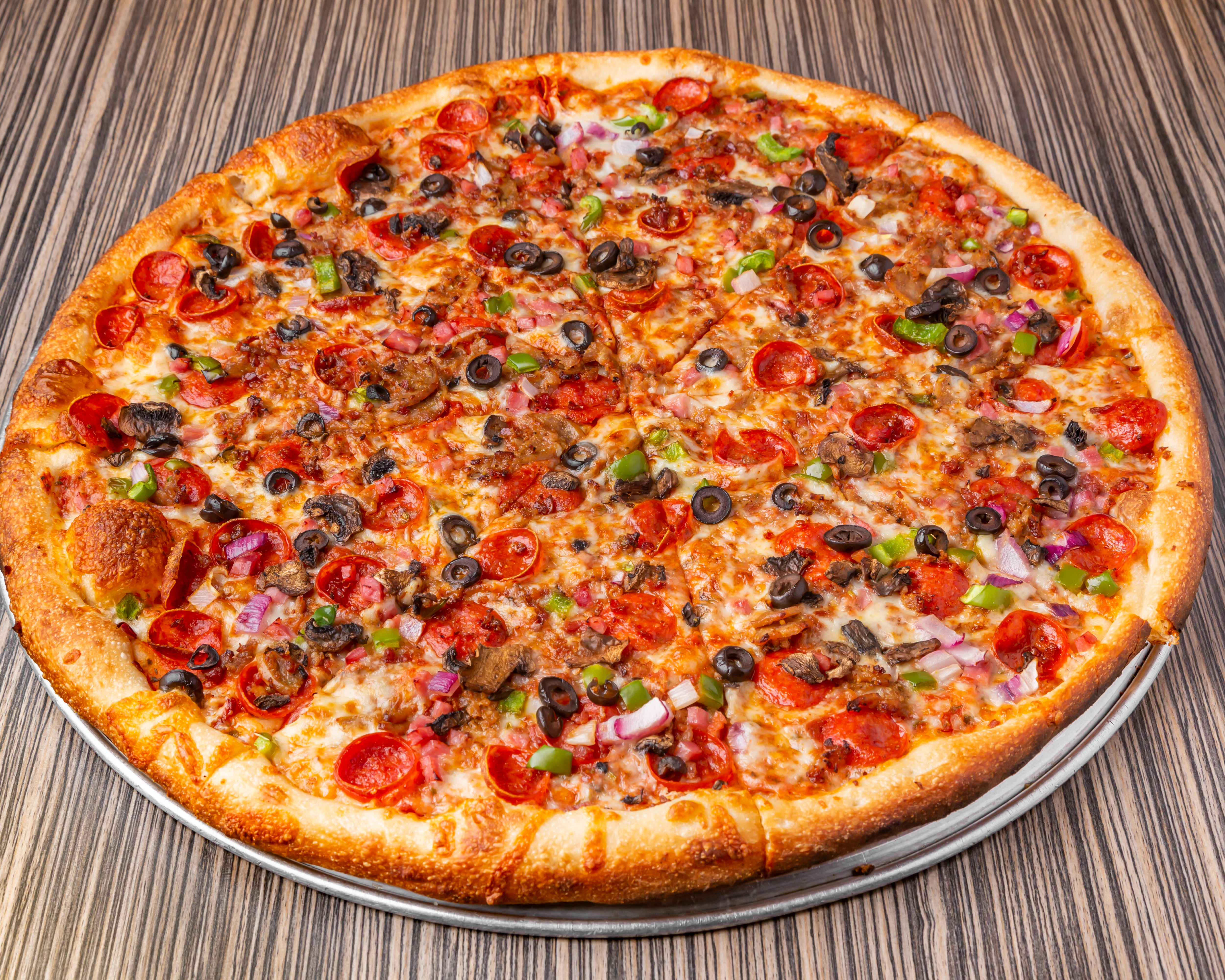 a pizza sitting on top of a wooden table