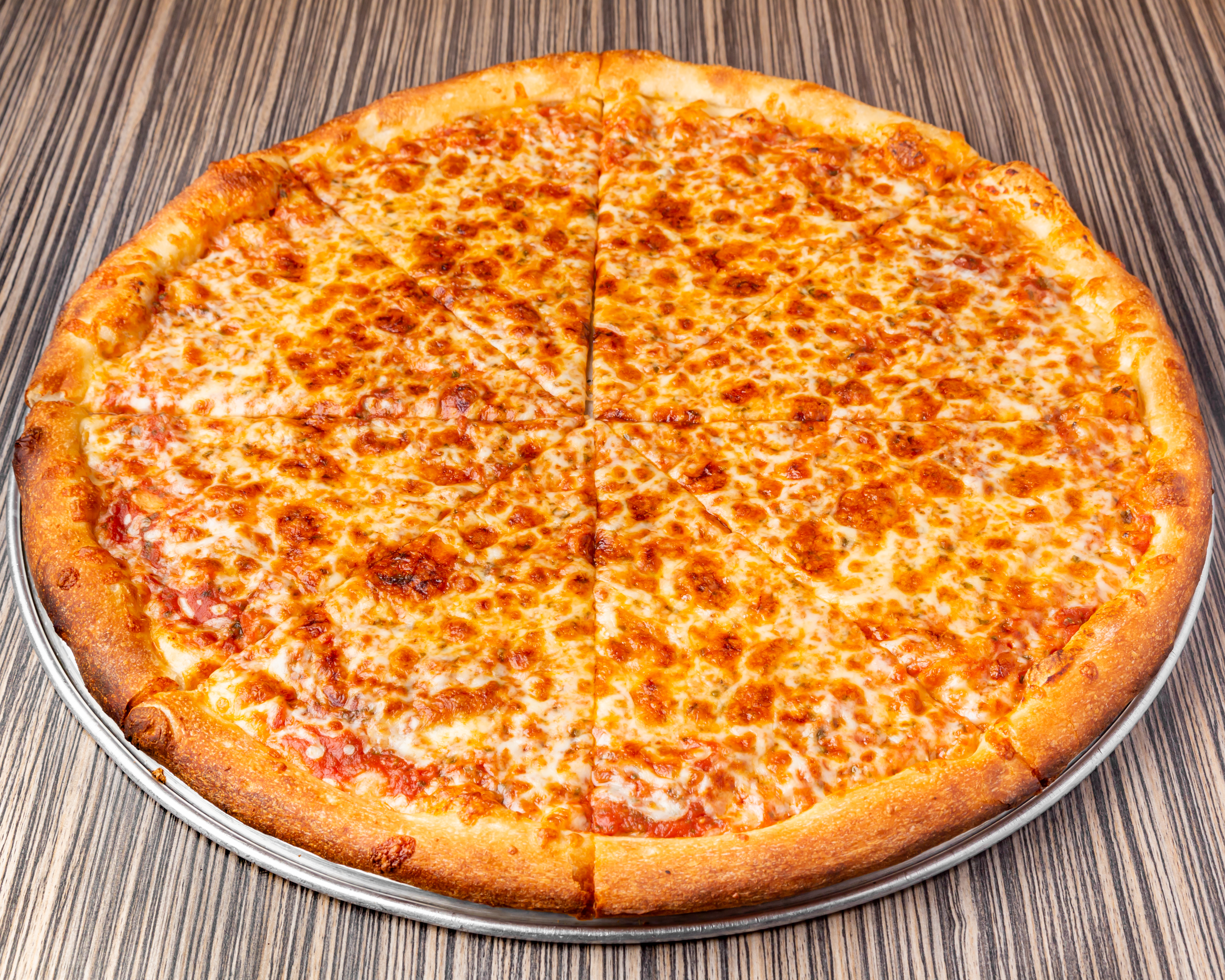 a pizza sitting on top of a wooden table