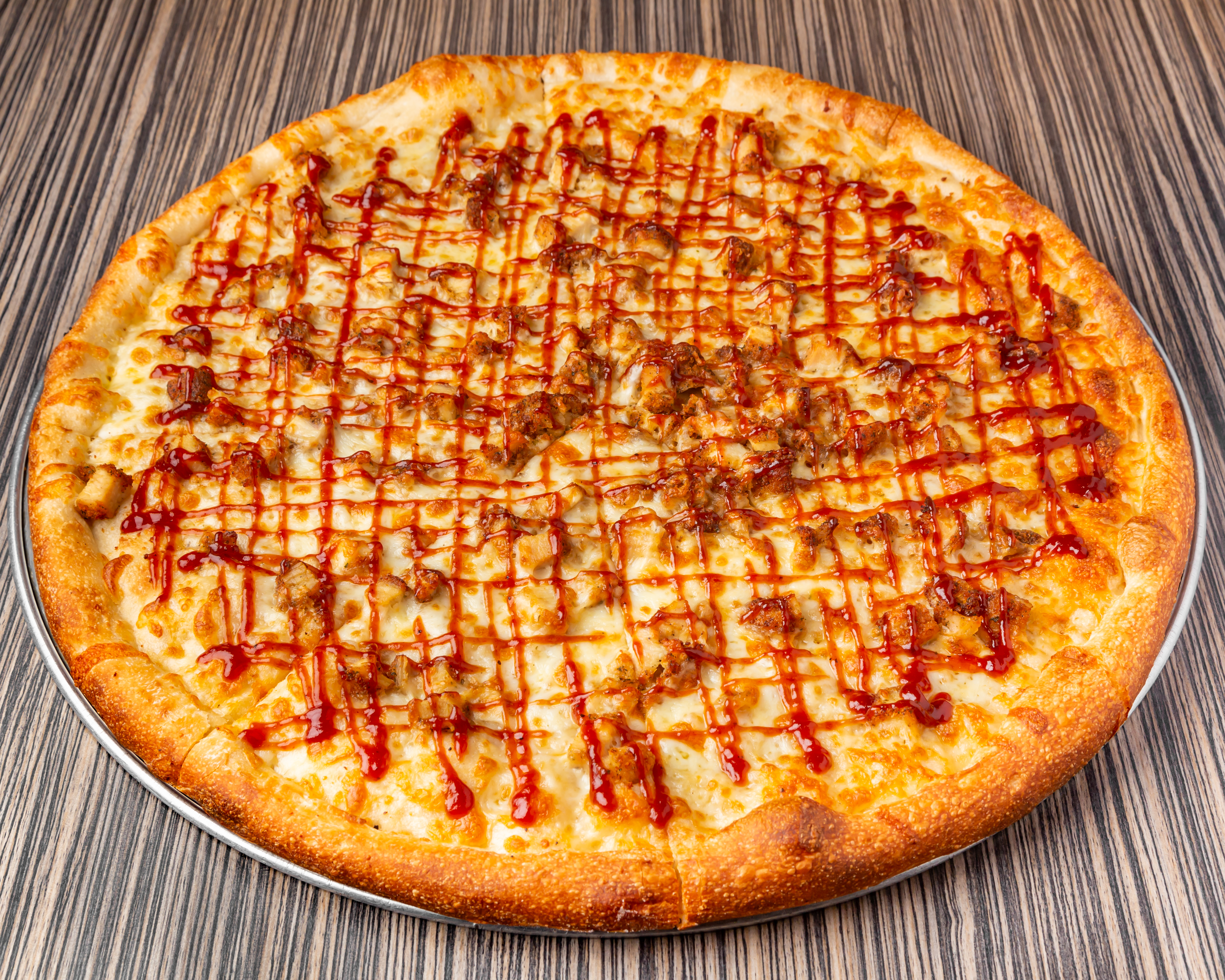 a pizza sitting on top of a wooden table