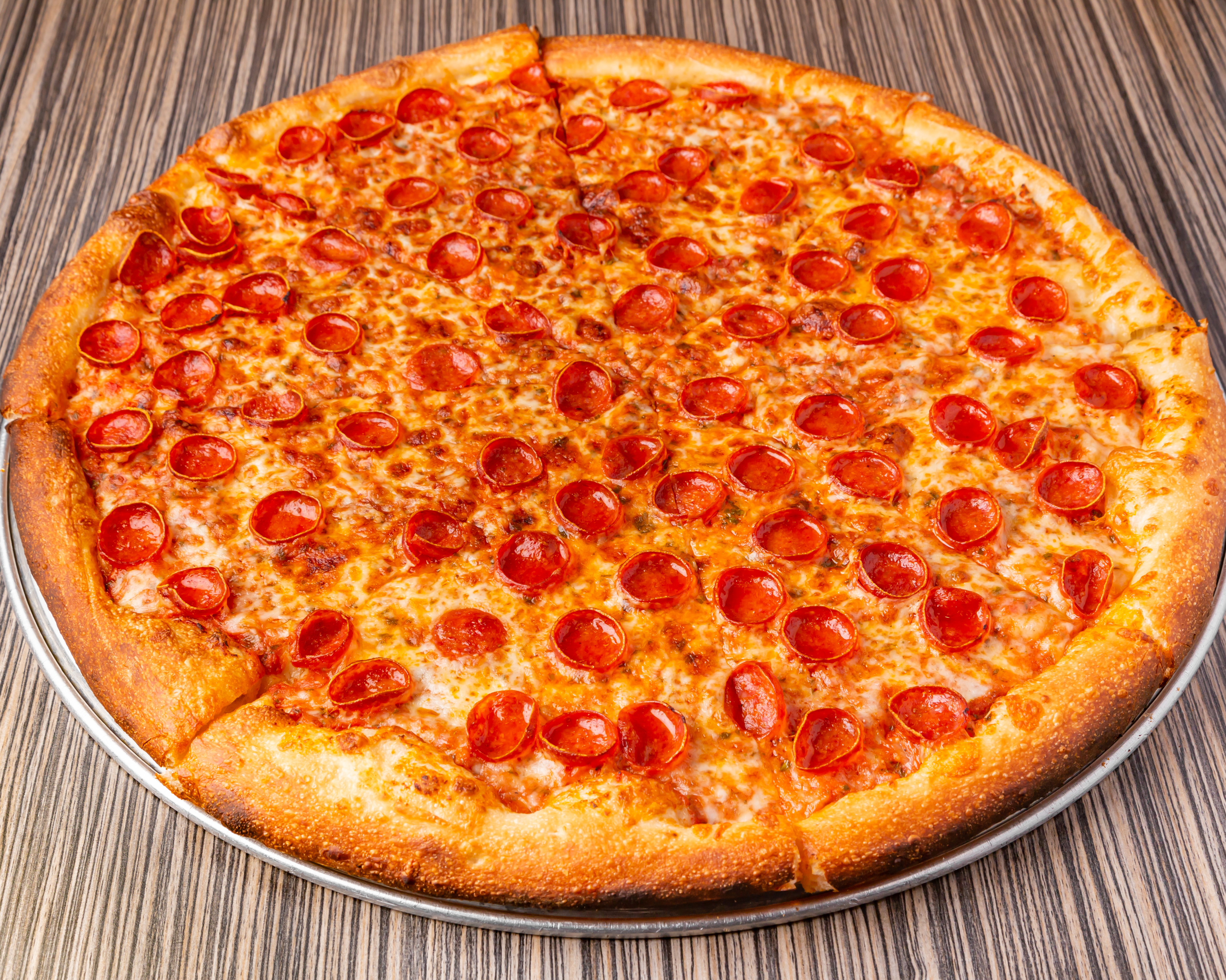 a pizza sitting on top of a wooden table
