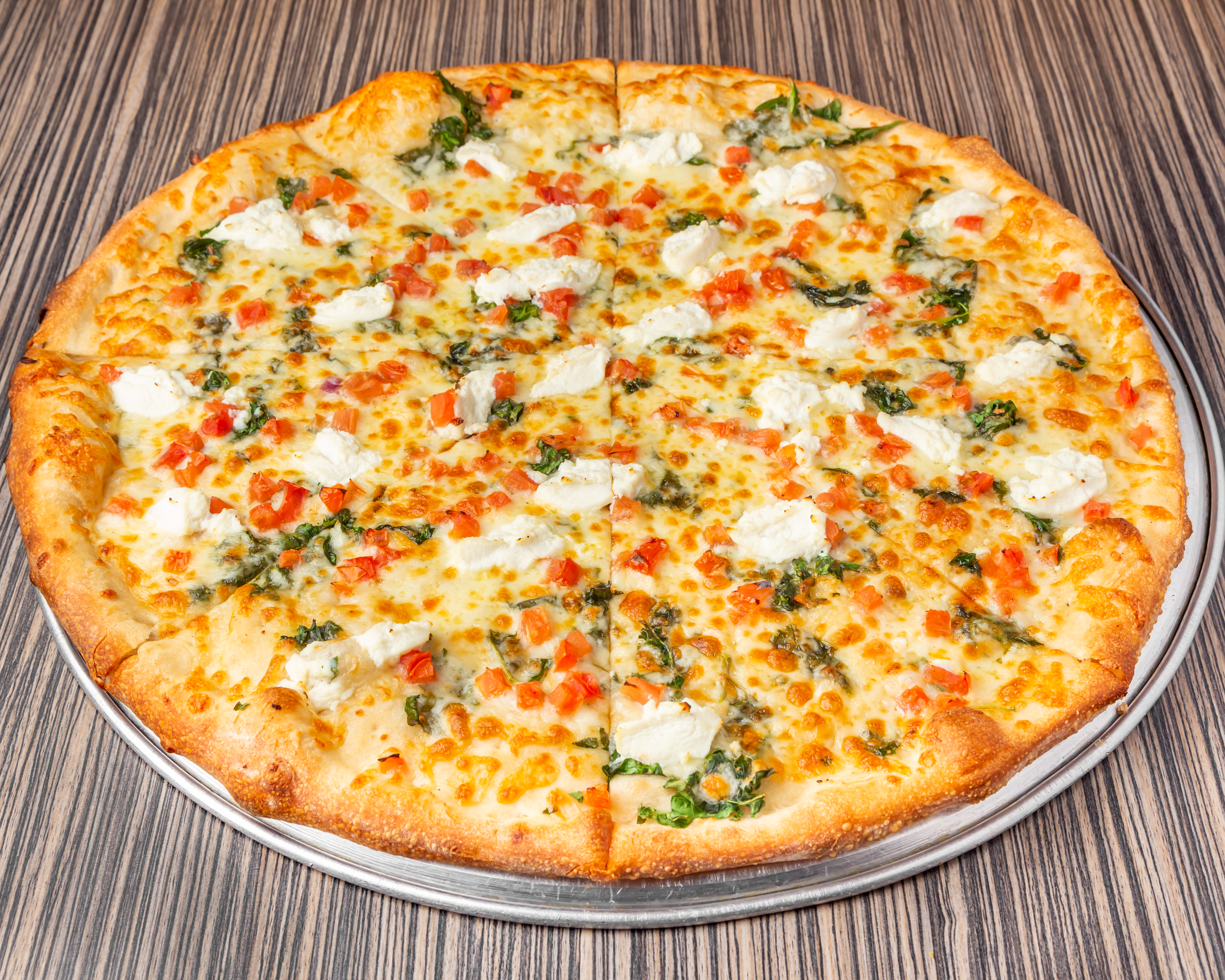 a pizza sitting on top of a wooden table