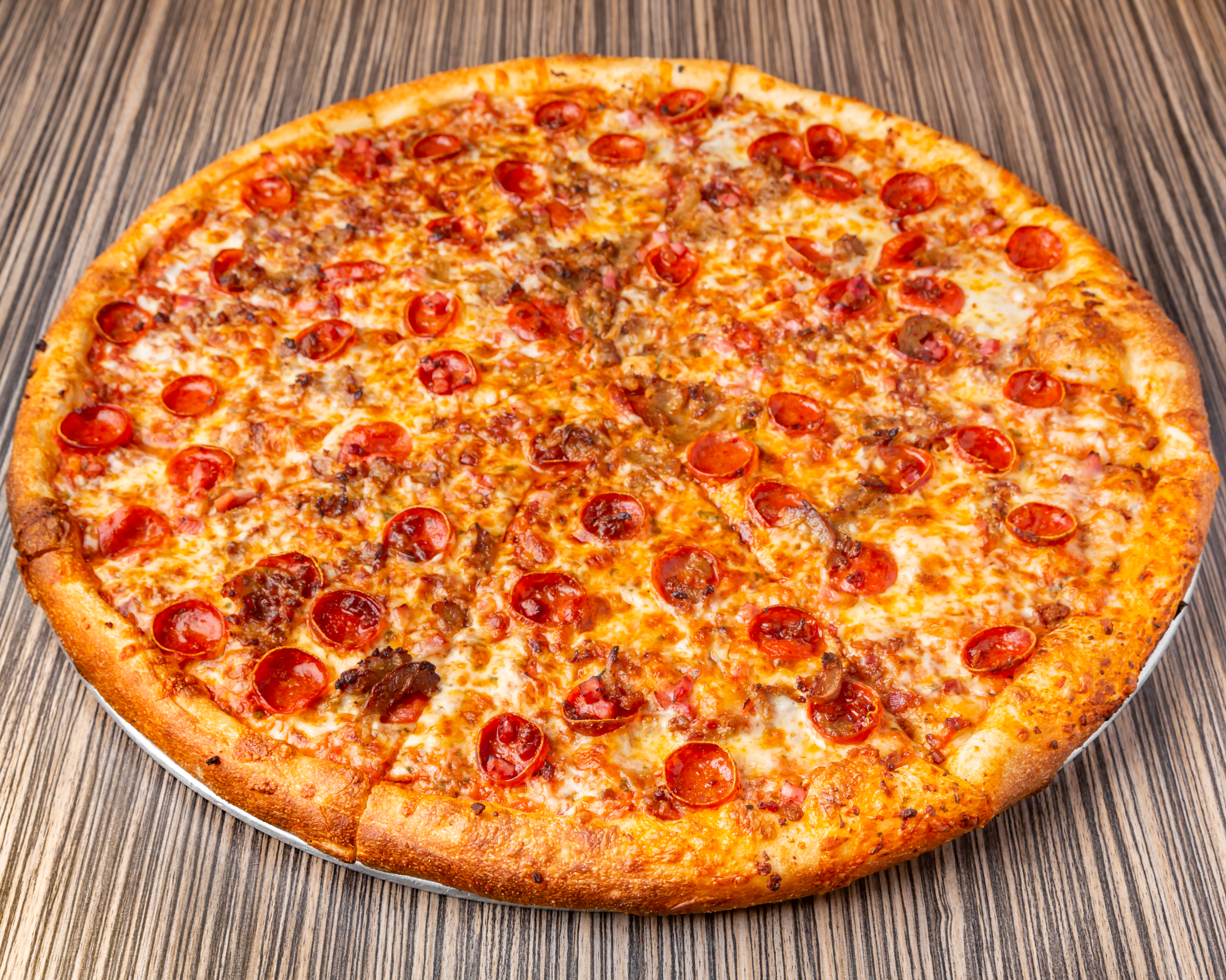 a pizza sitting on top of a wooden cutting board