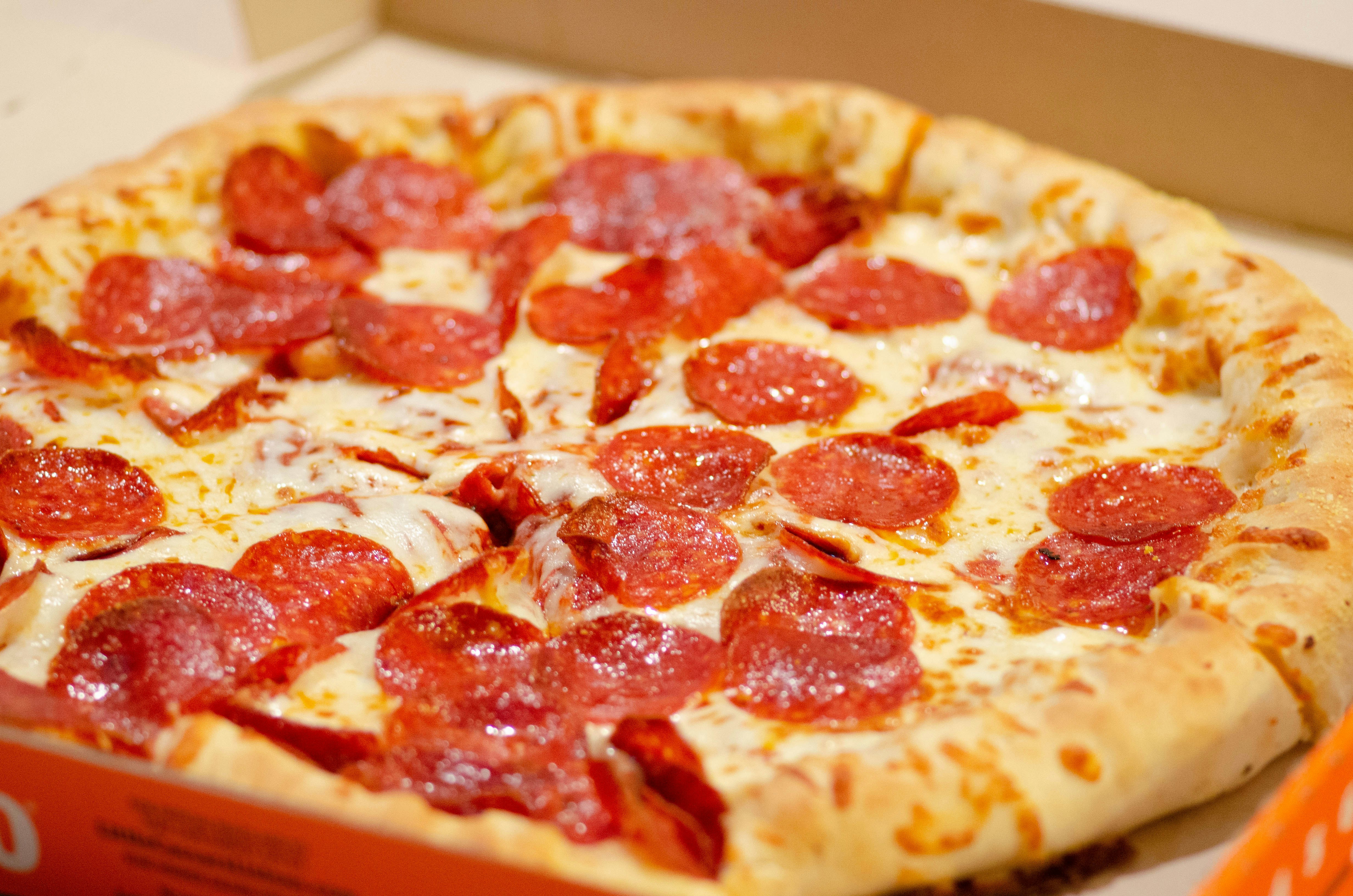a small pepperoni pizza sitting on top of a table