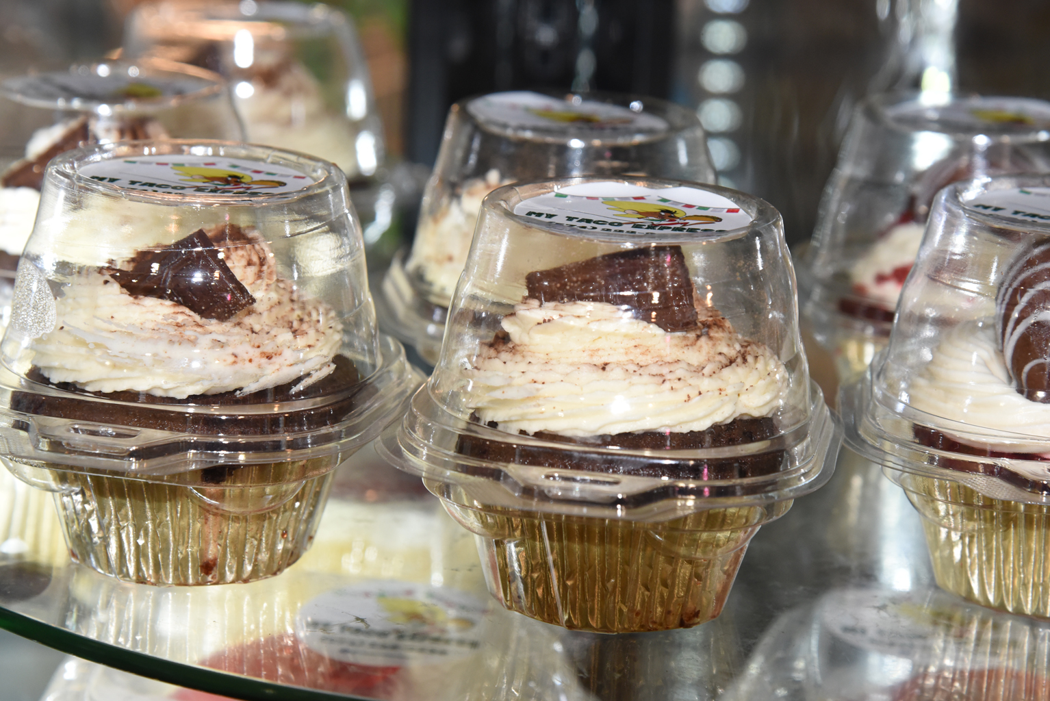 a piece of cake sitting on top of a table filled with wine glasses