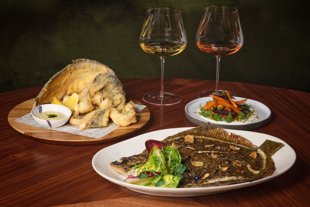 a plate of food and a glass of wine