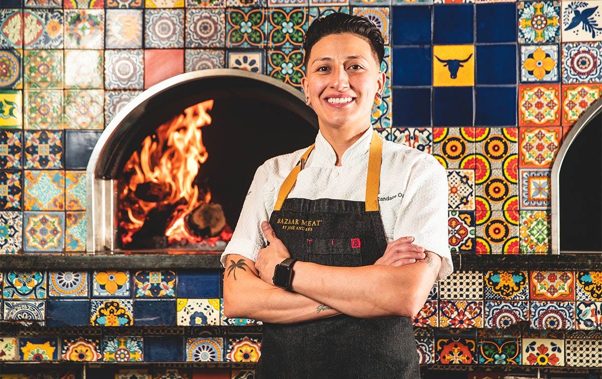 a person standing next to a fireplace