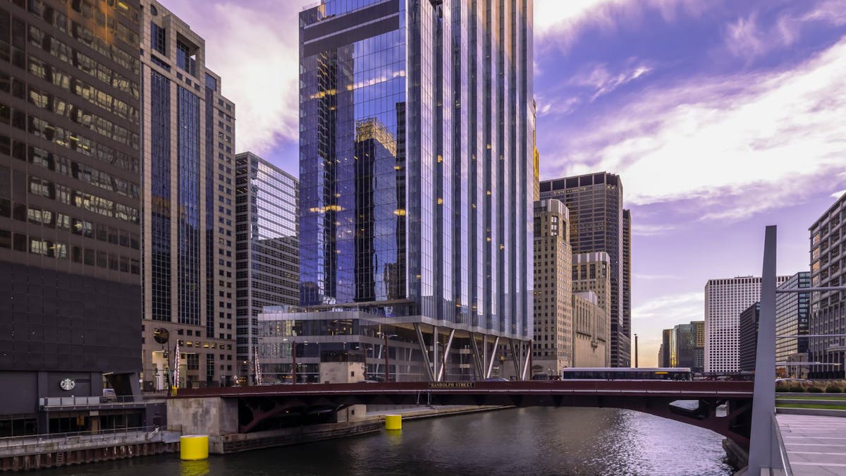 a bridge over a body of water with a city in the background