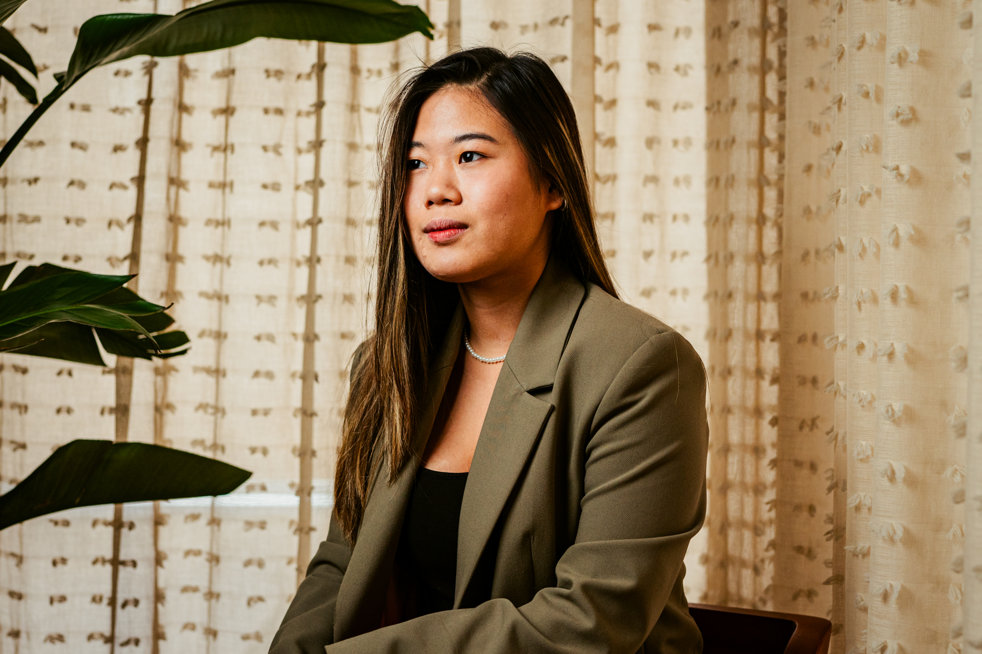 a person standing in front of a curtain