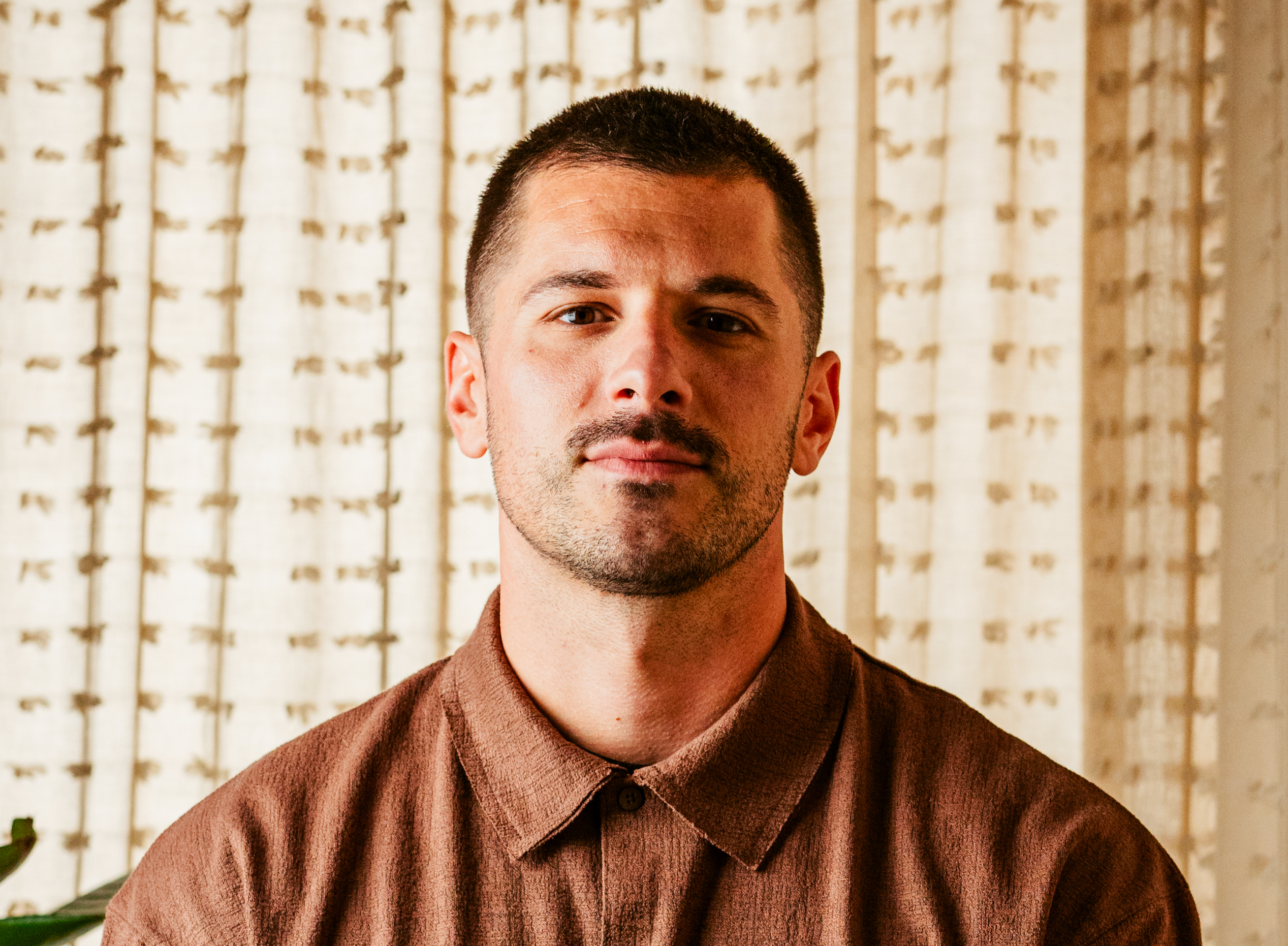 a man wearing glasses and looking at the camera