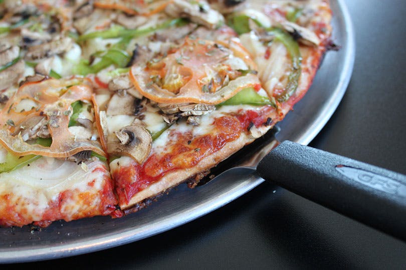 a pizza sitting on top of a plate of food