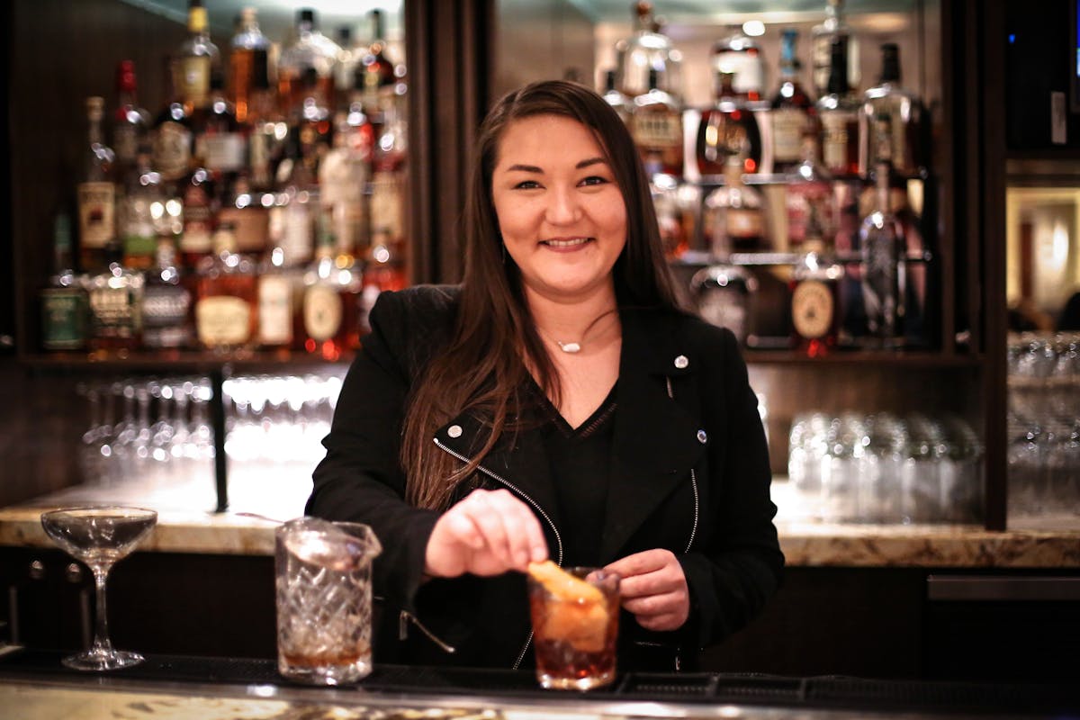 a woman sitting at a table in a restaurant