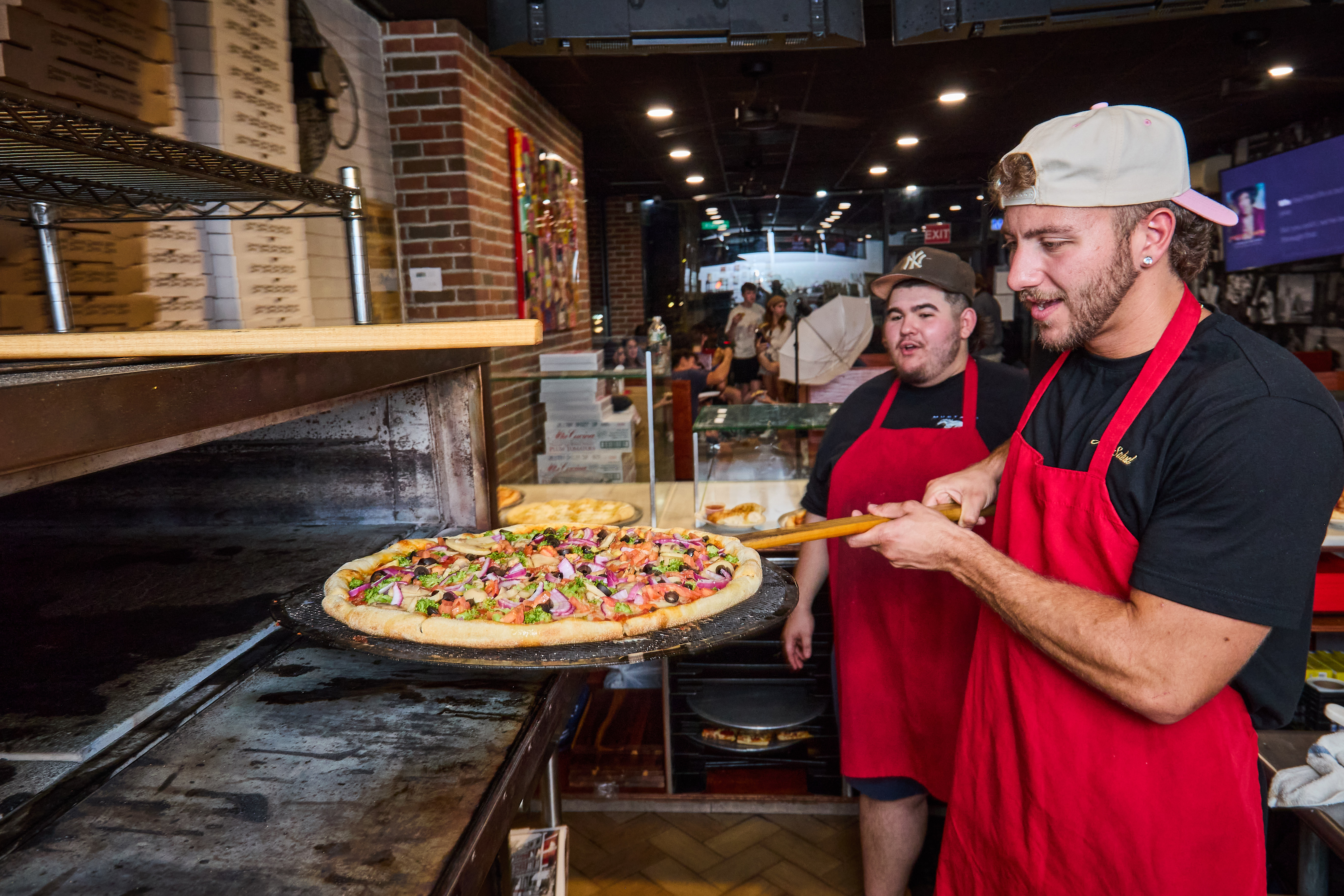 a man cooking pizza