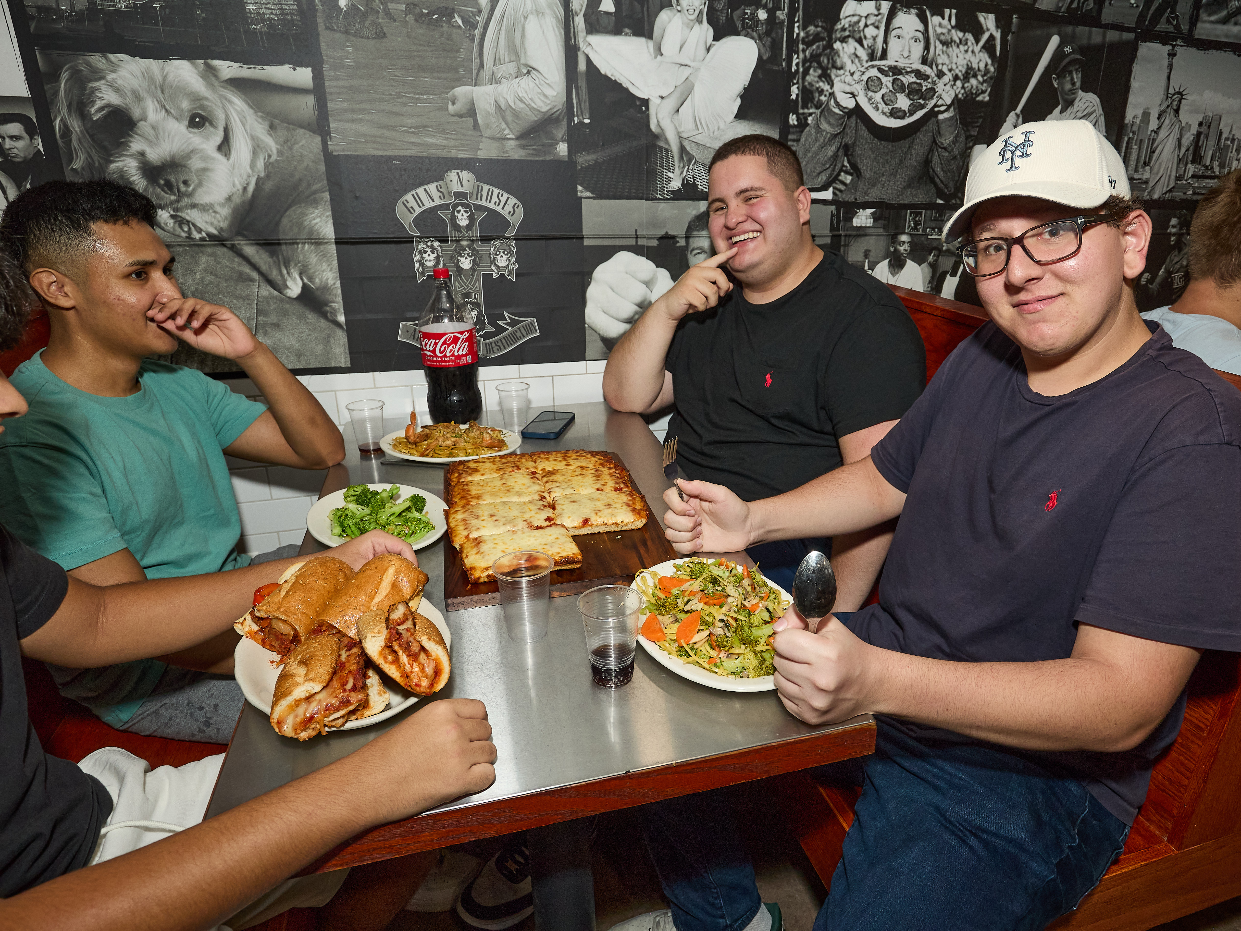 a group of people sitting at a table with food