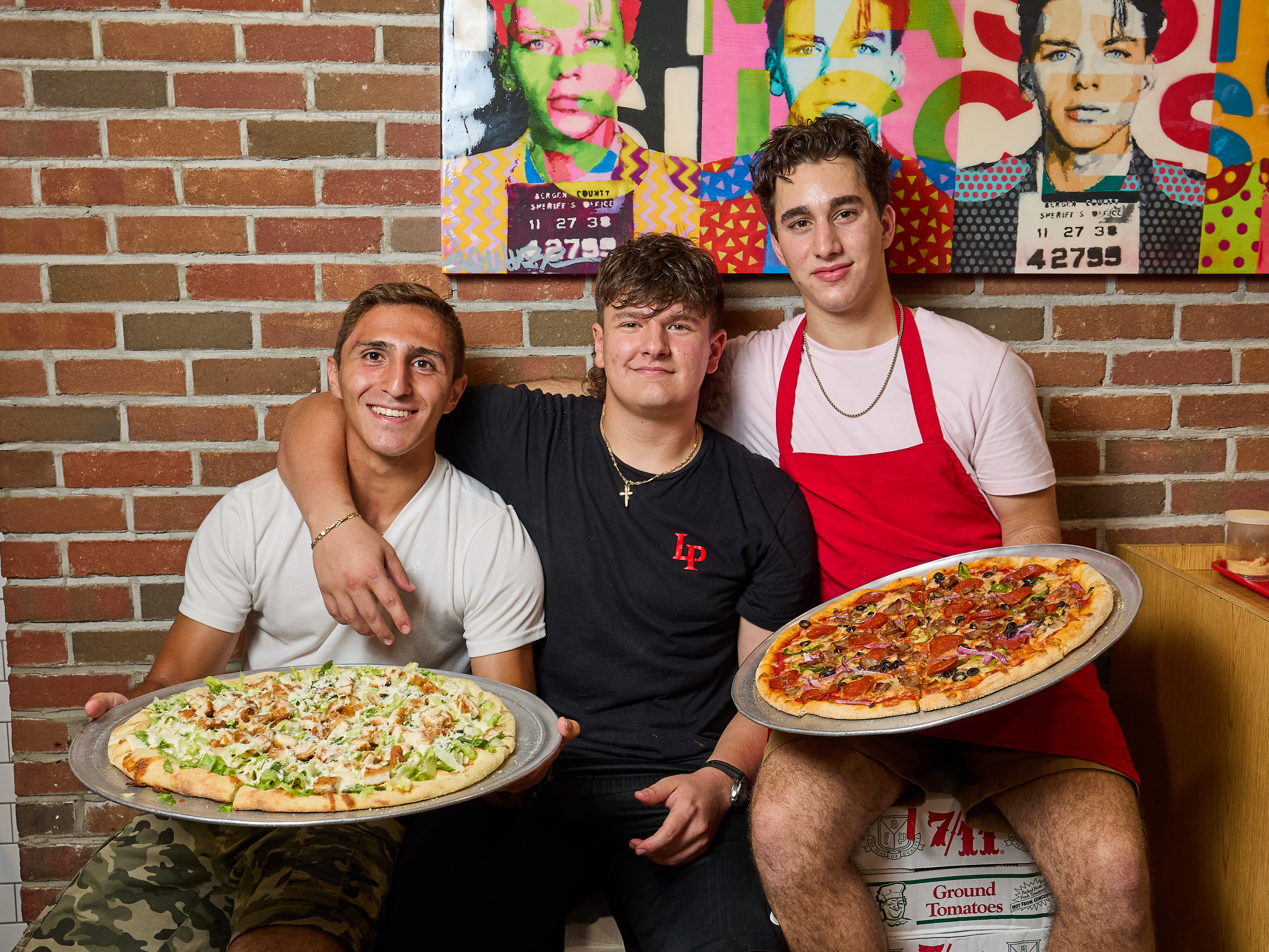 Levent Gülen et al. standing in front of a pizza
