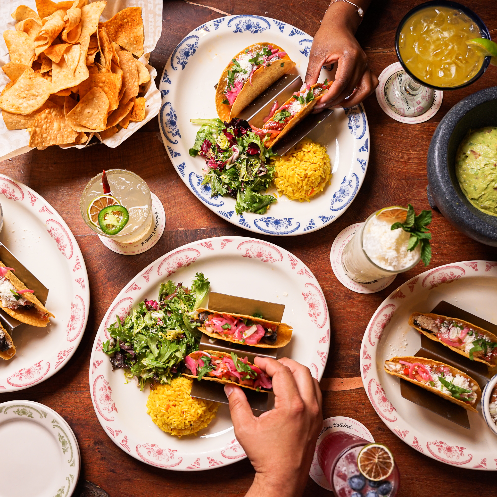 a group of people sitting at a table with a plate of food