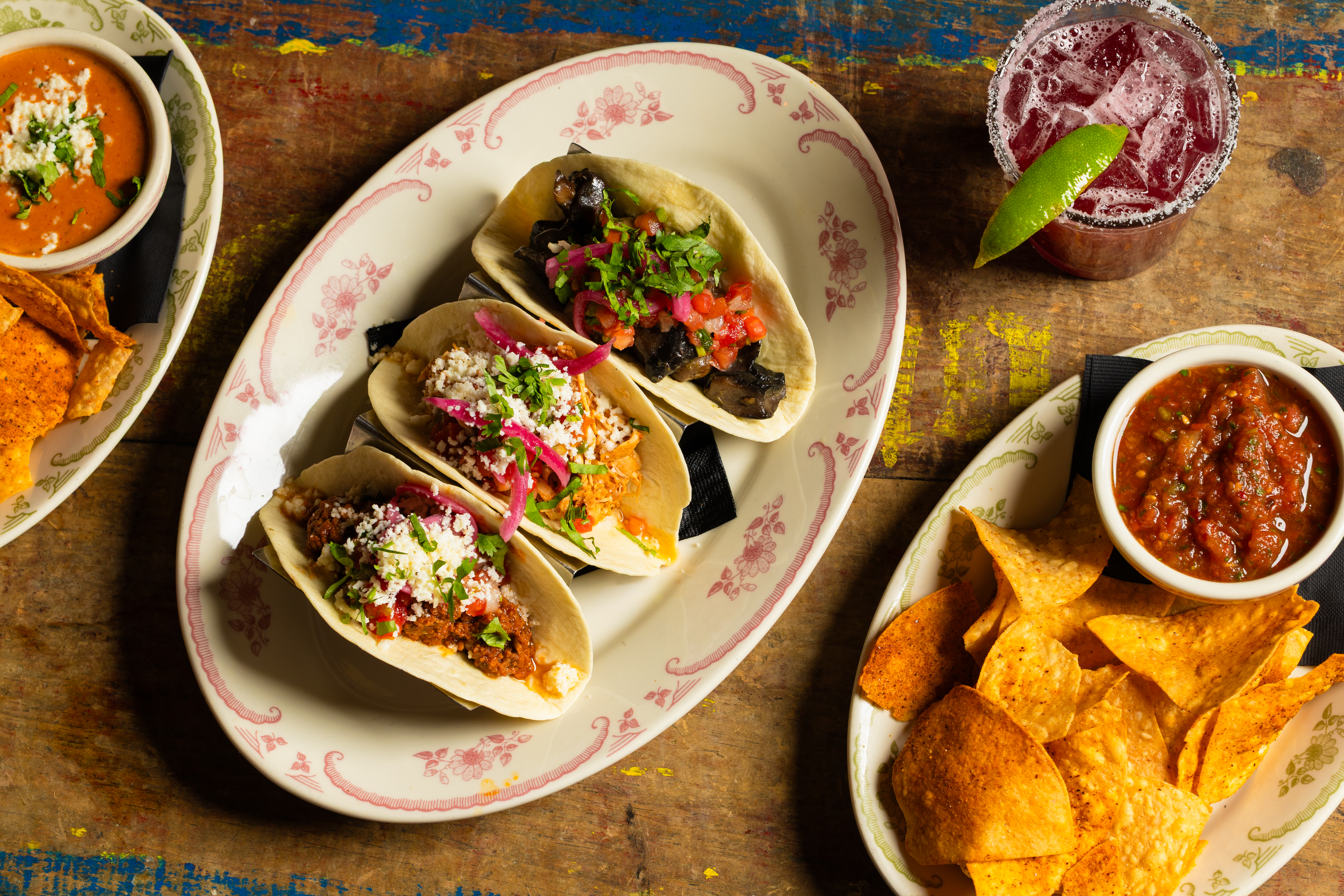 Three street tacos with a margarita, chips and salsa at Rocco's Tacos & Tequila Bar