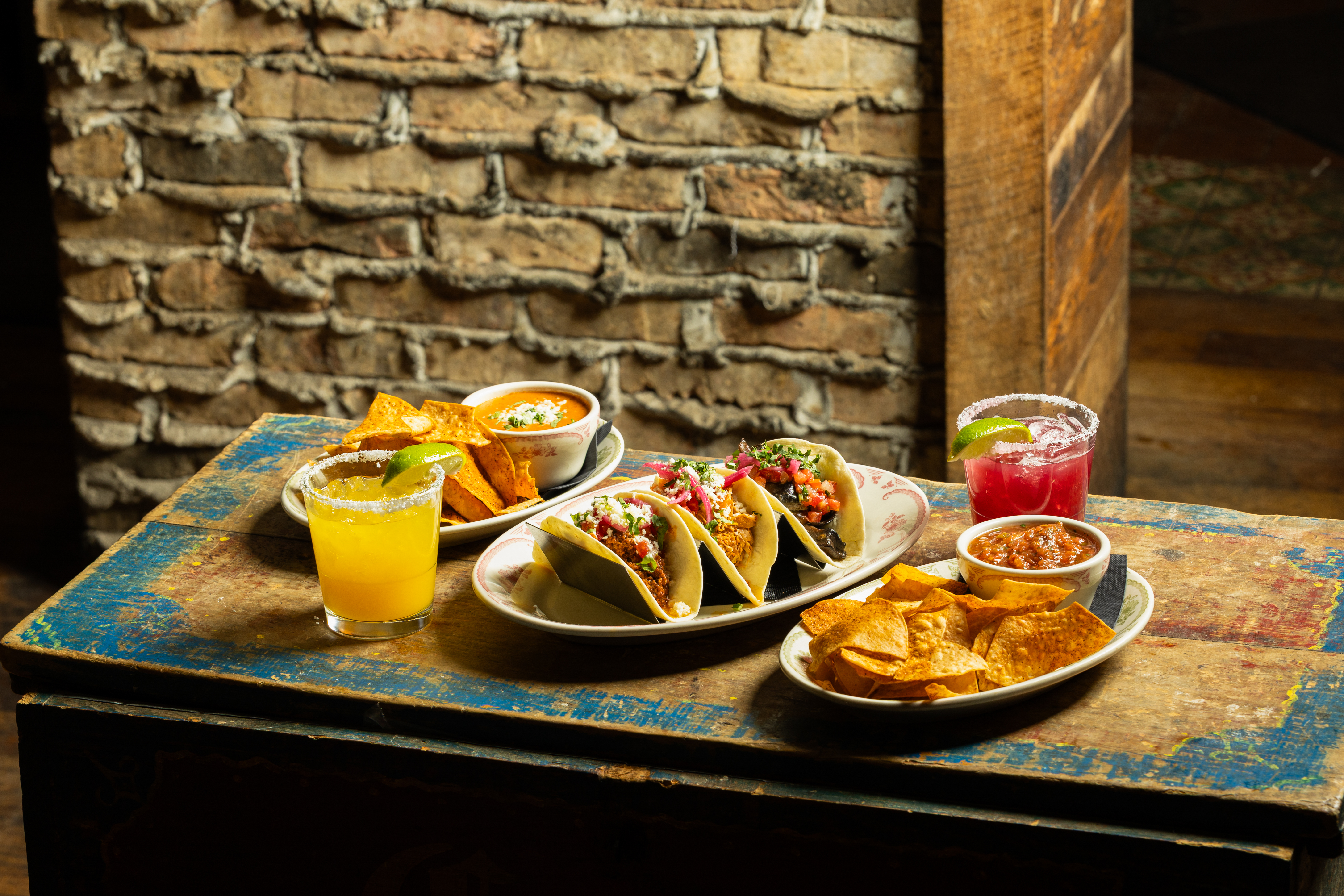 Tacos, chips with salsa and queso, and margaritas on a table at Rocco's Tacos on Las Olas in Fort Lauderdale