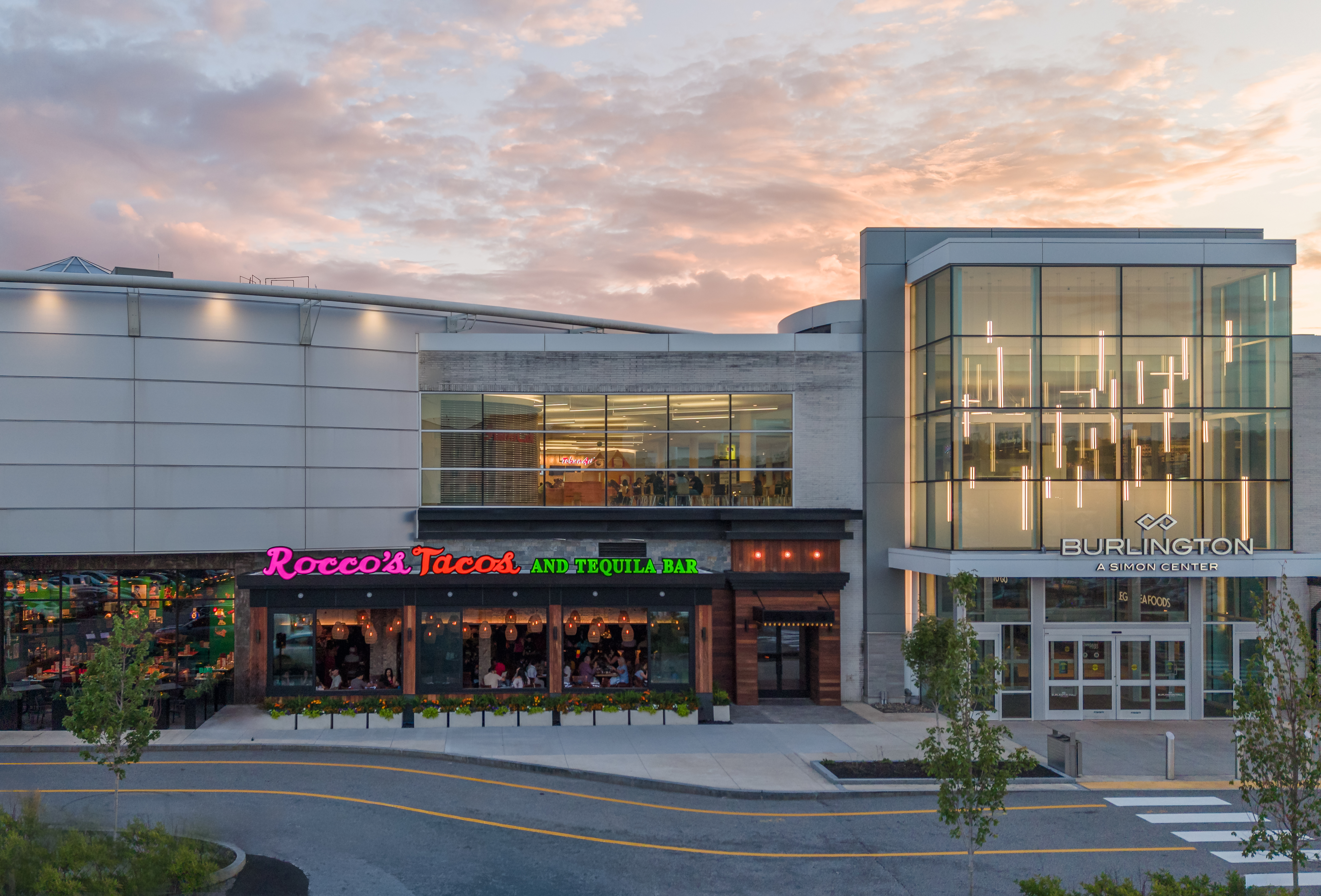 Rocco's Tacos & Tequila Bar exterior at sunset beside the Burlington Mall entrance in Burlington, MA