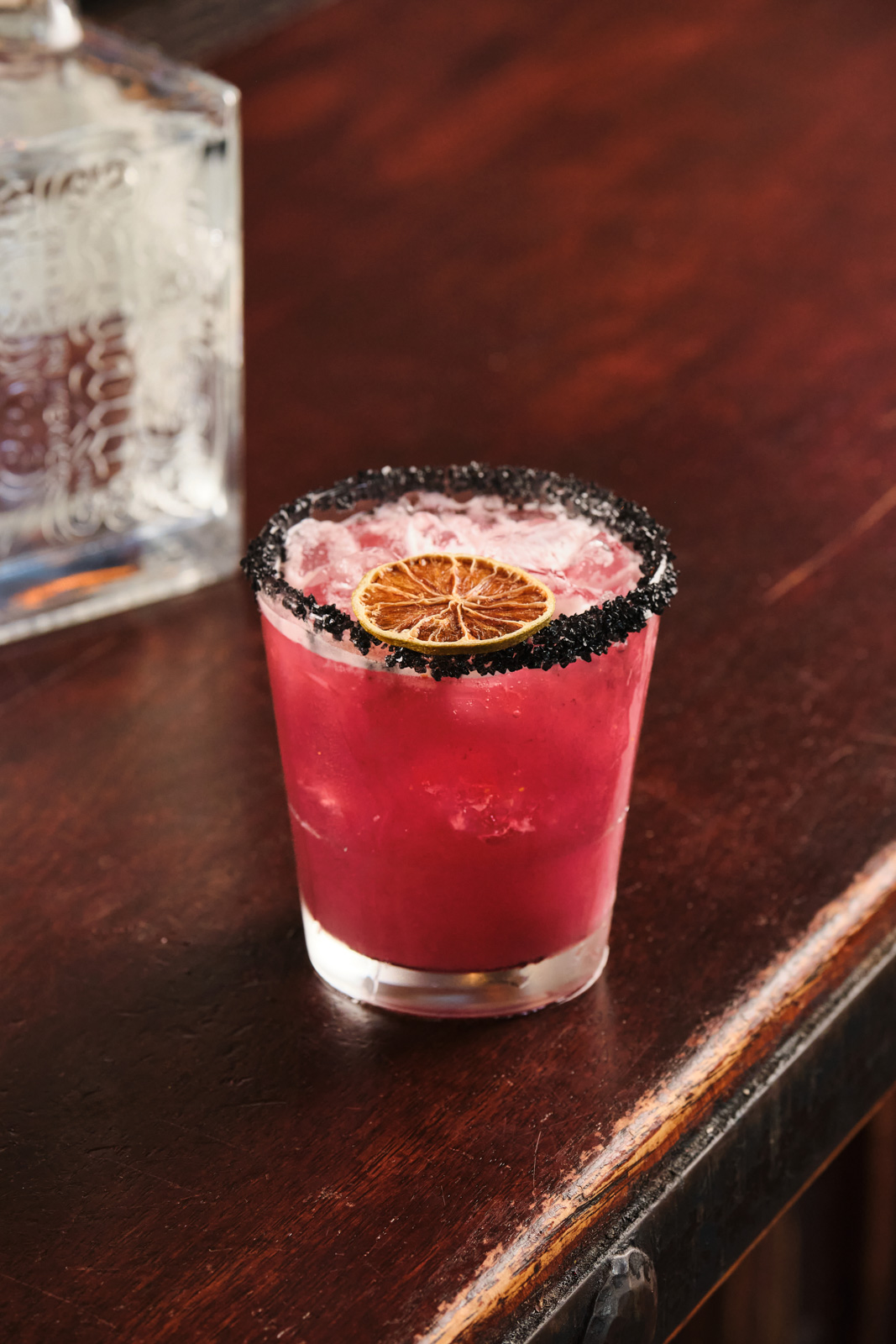 a cup of coffee sitting on top of a wooden table