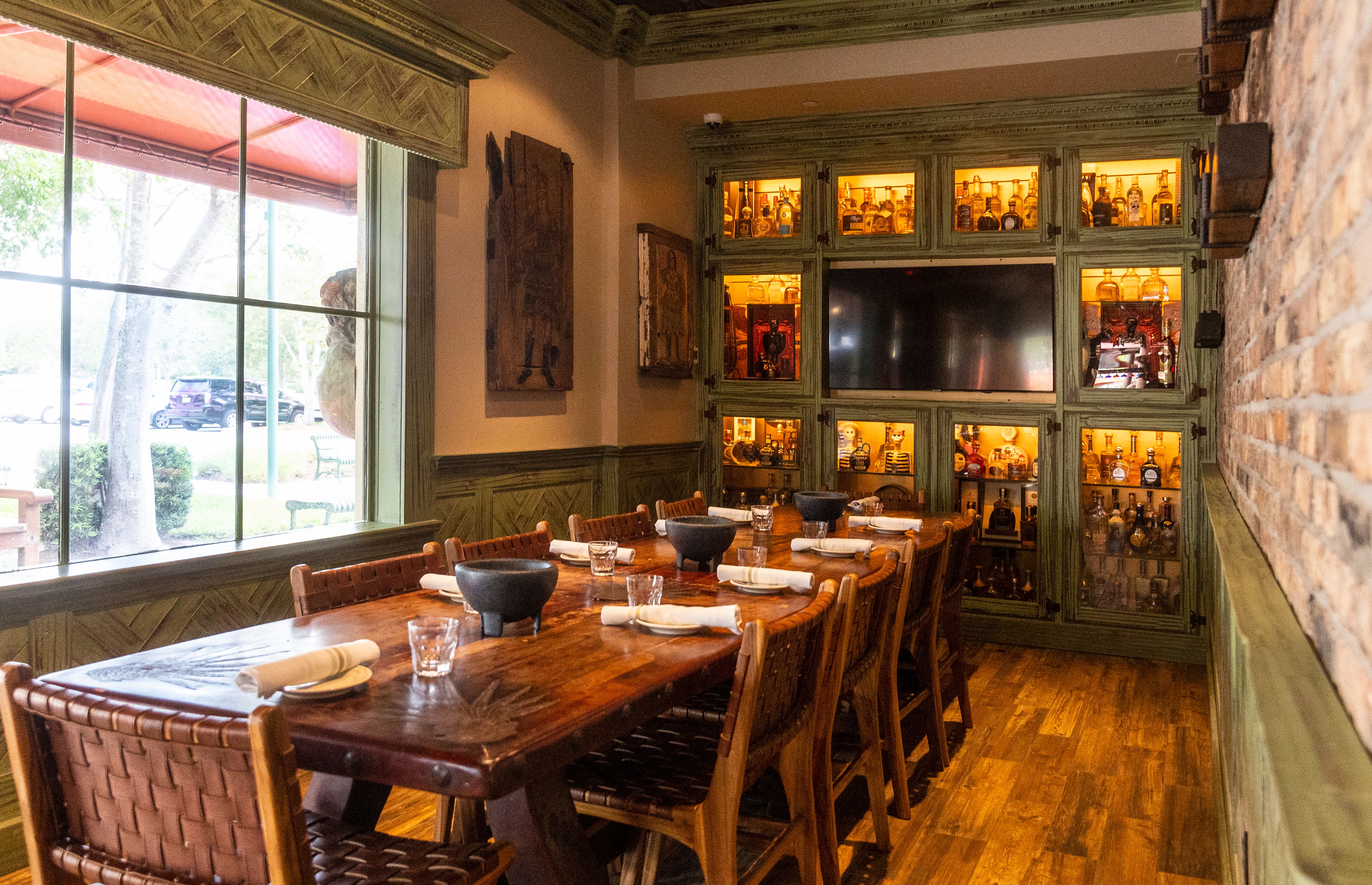 a dining room table in front of a window