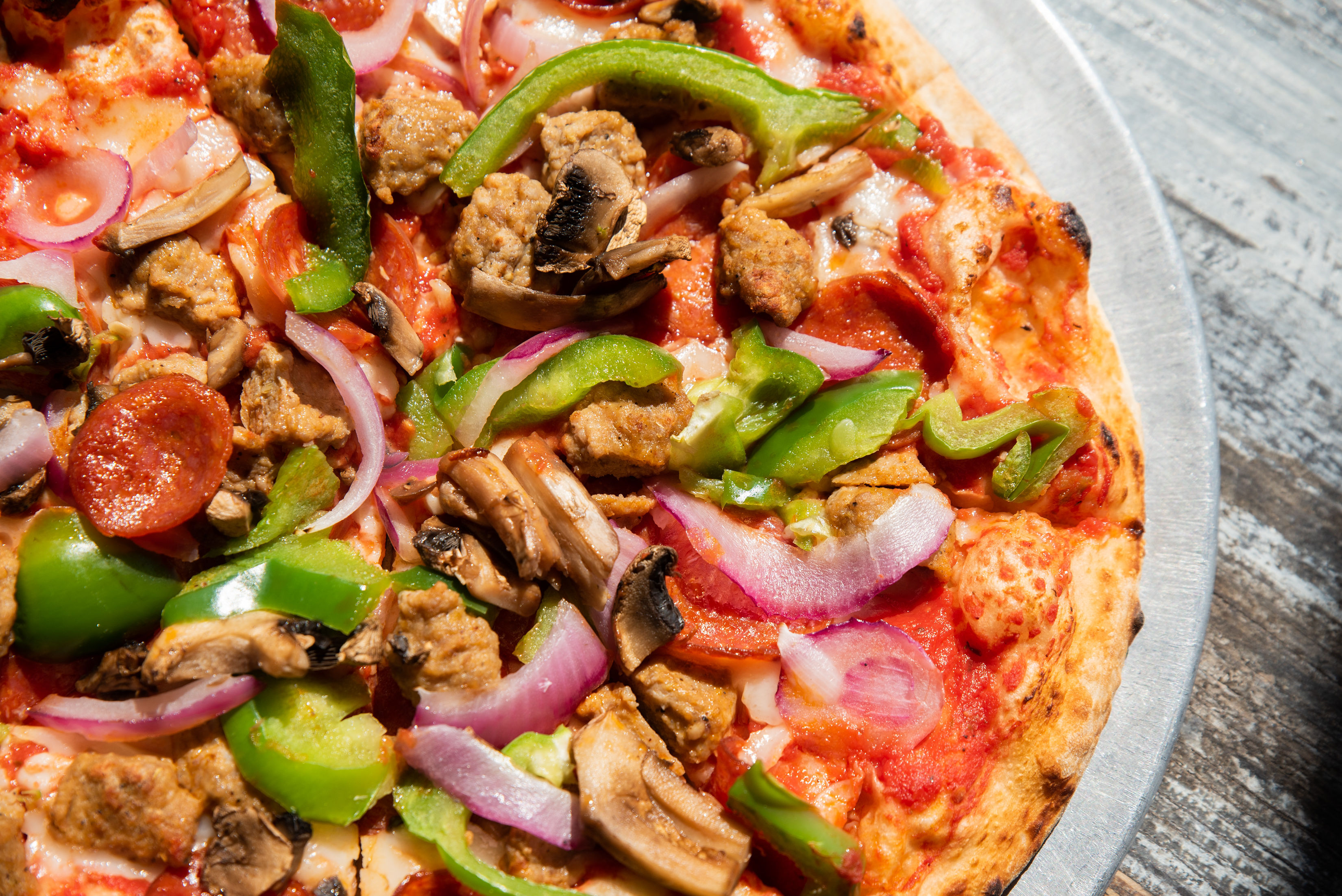 a pizza sitting on top of a plate of food