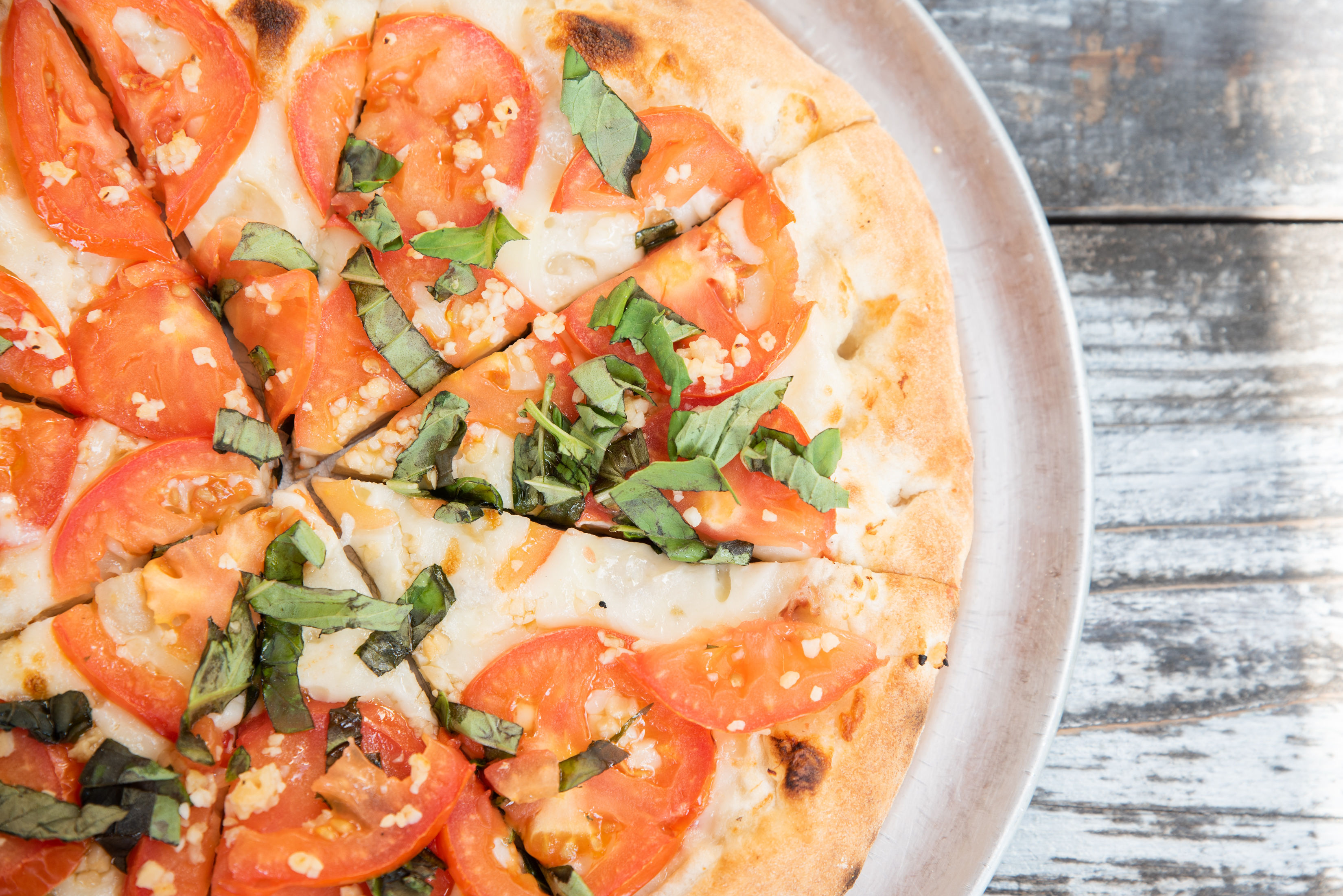 a pizza sitting on top of a plate of food