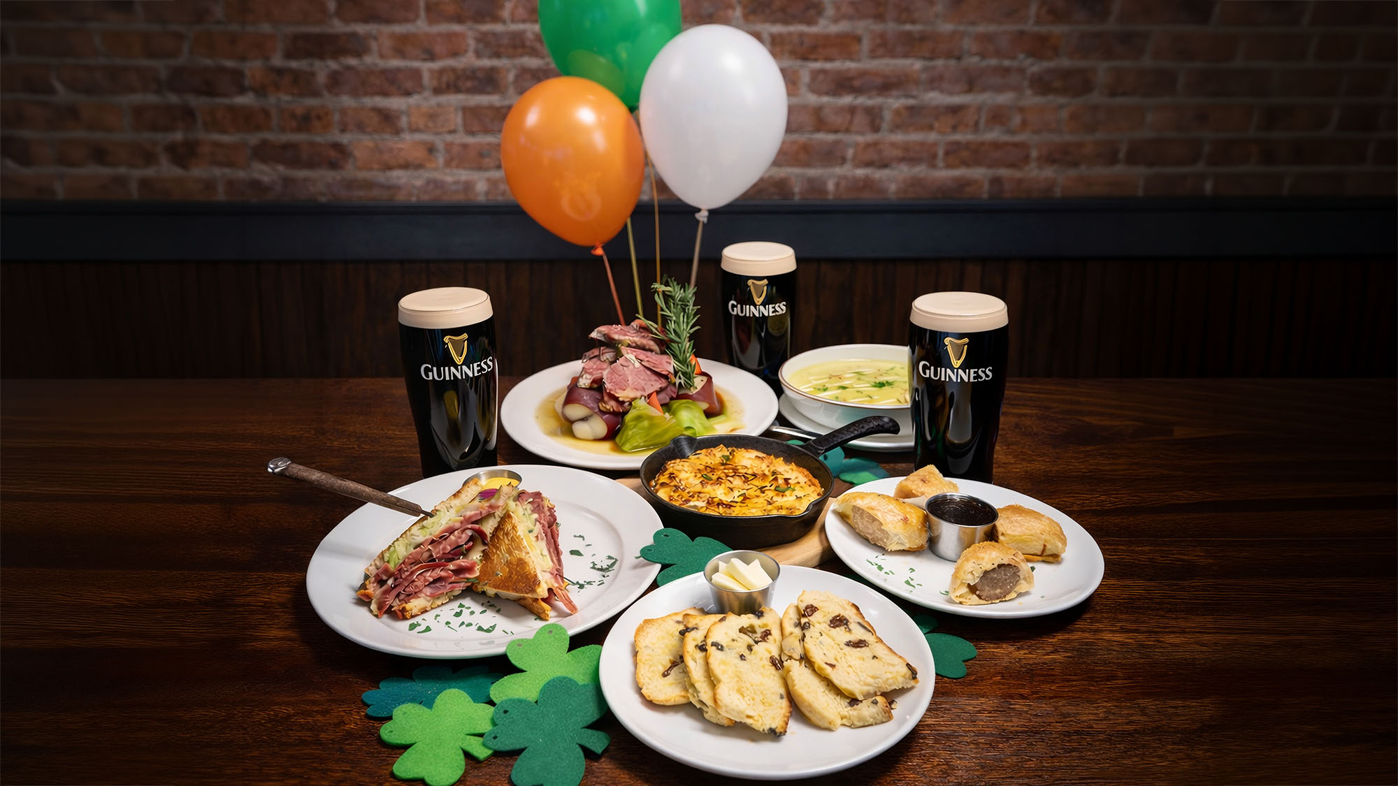 Rivercrest's St. Patrick's Day dishes with pints of Guinness on a wooden table in Astoria Queens