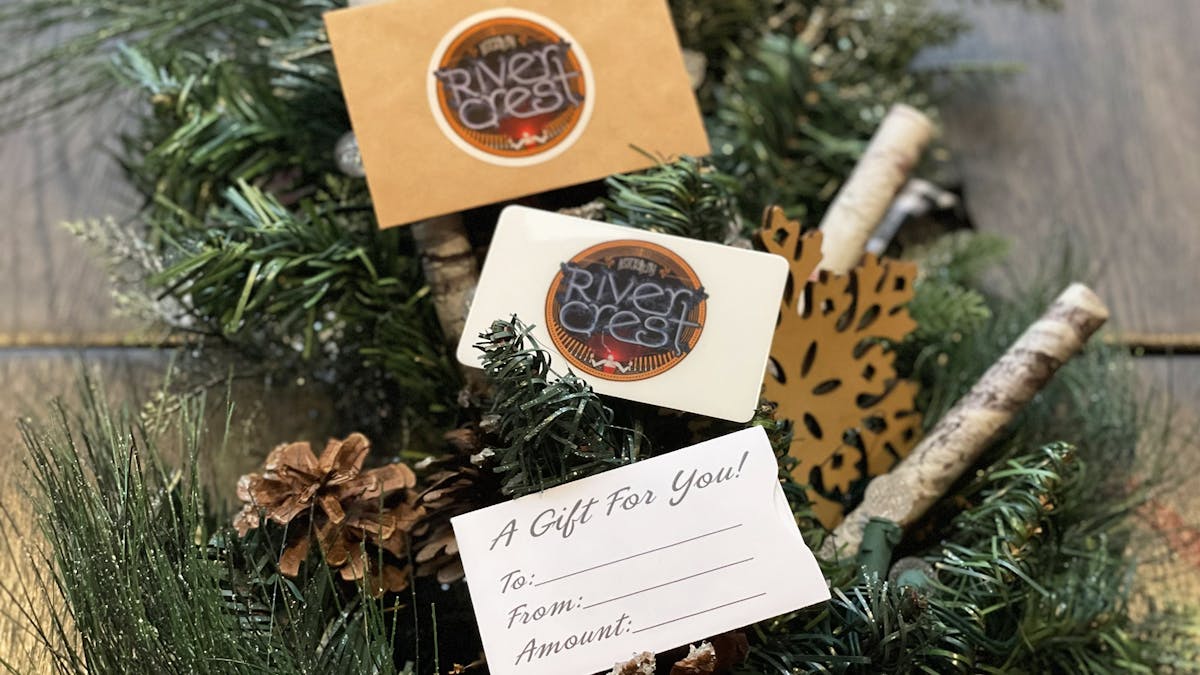 photo of Rivercrest gift cards on festive sprigs of pines