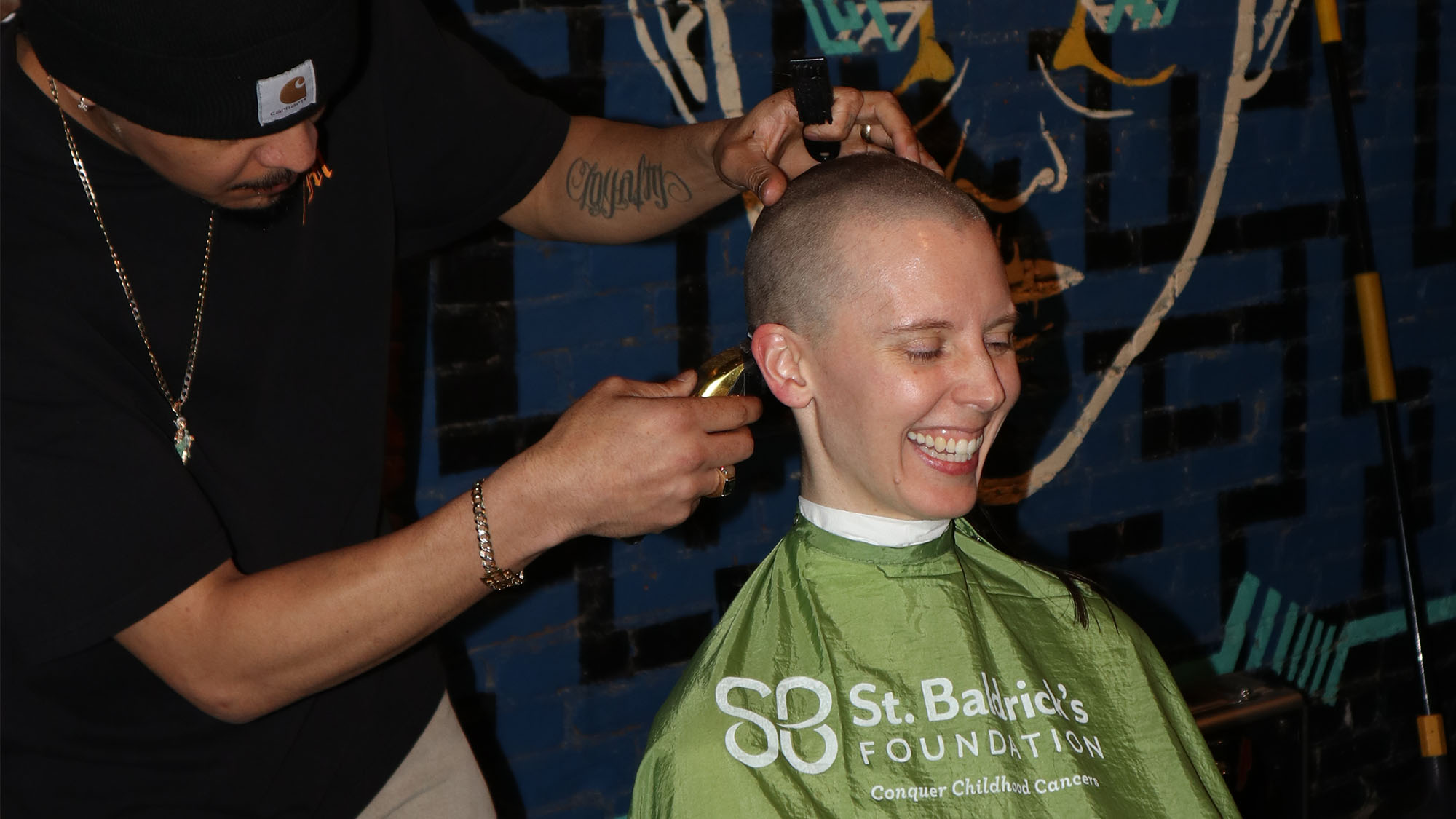 volunteer shaving their hair for St Baldrick's at Rivercrest for kids' cancer