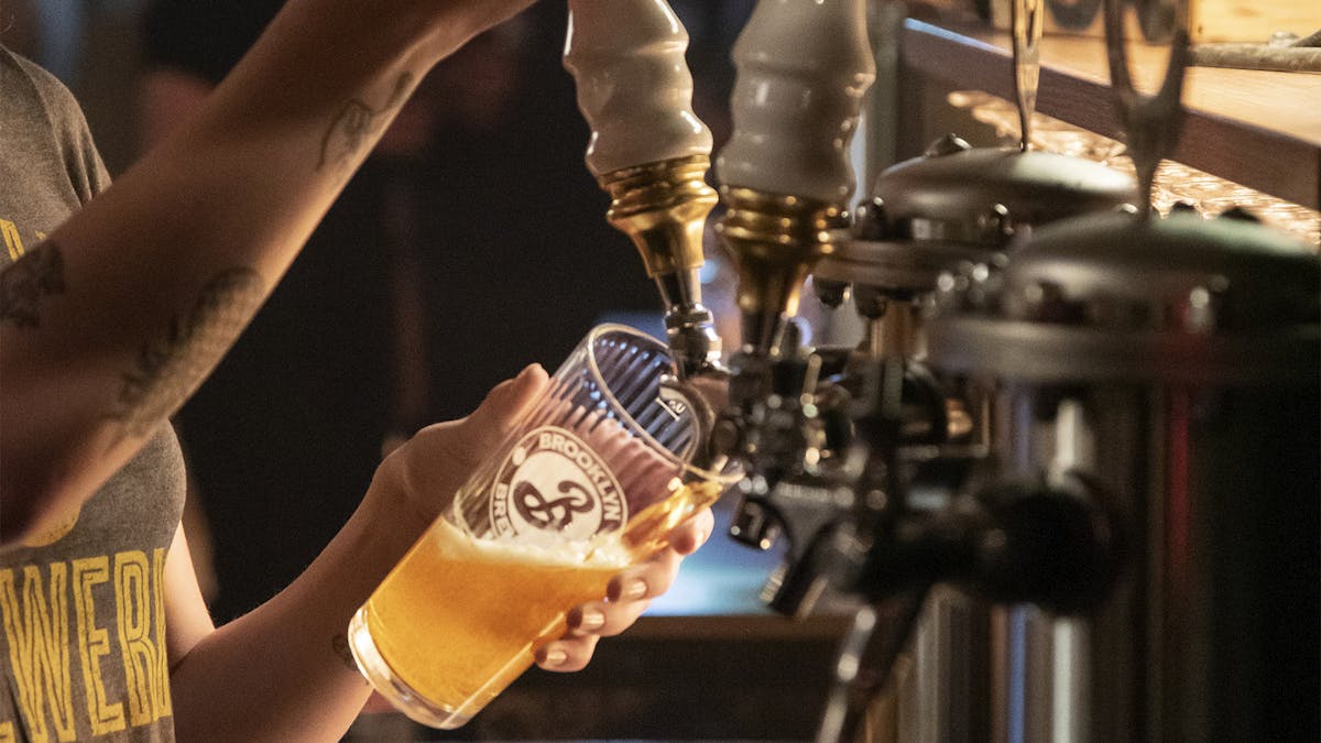 bartender pouring a pint of Brooklyn Brewery's The New York Foundling Pilsner