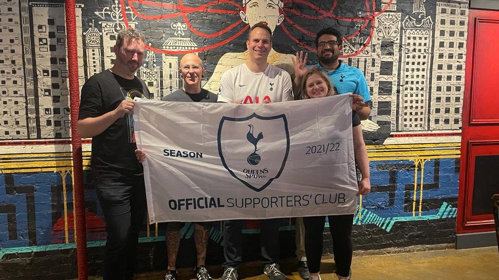 Queens Spurs Supporters Club inside Rivercrest holding their banner