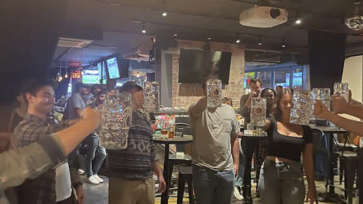 guests participating in Rivercrest's stein-hoisting competition during Oktoberfest in Astoria, Queens