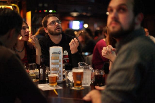 a group of people are drinking from a glass