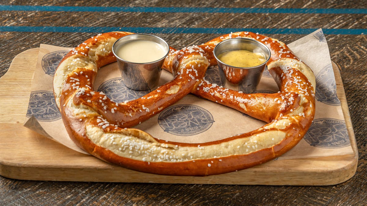 Rivercrest's Uber Bavarian Pretzel with IPA Mustard on a wood board