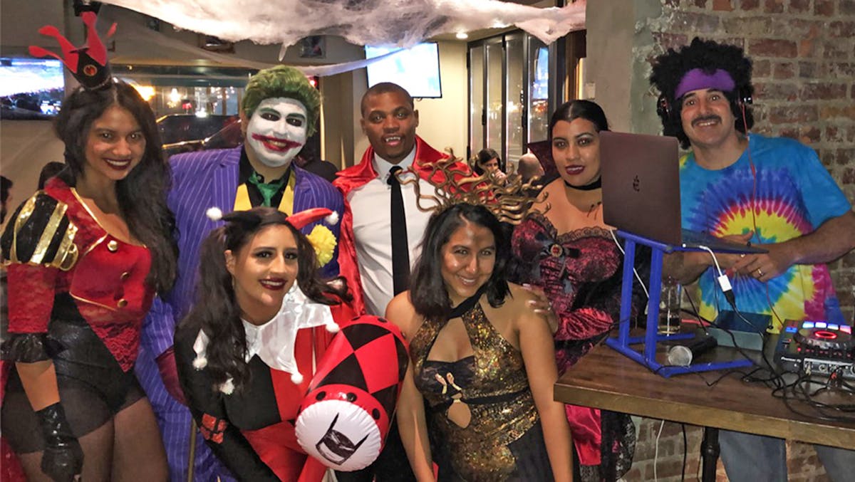 a group of people posing for the camera during Rivercrest's Halloween Party in Astoria
