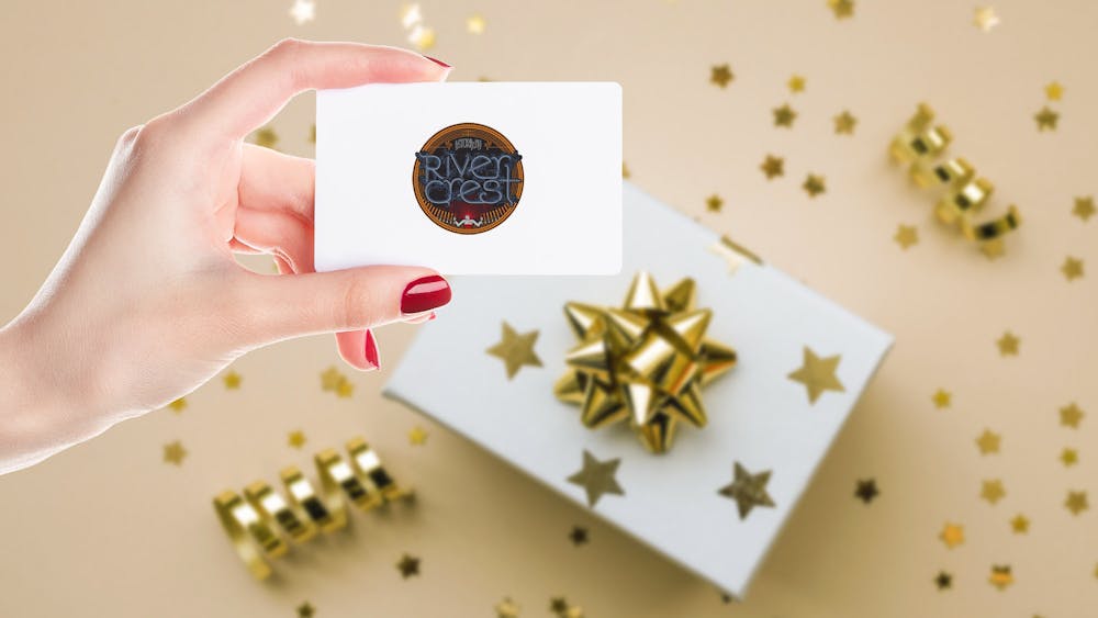 holding a Rivercrest gift card with a gift box in the background